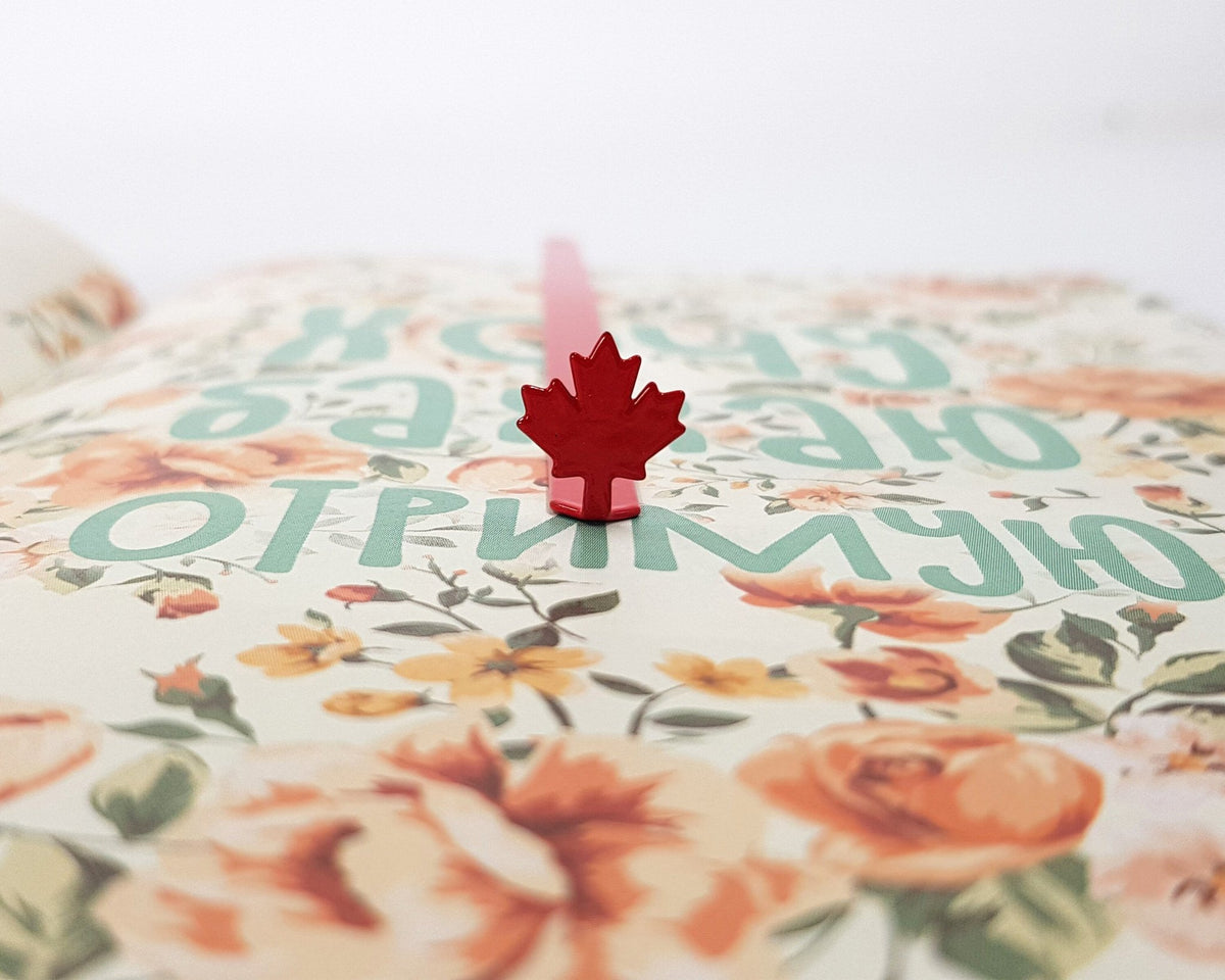 Canadian Maple Leaf metal bookmark in red on a coloured background