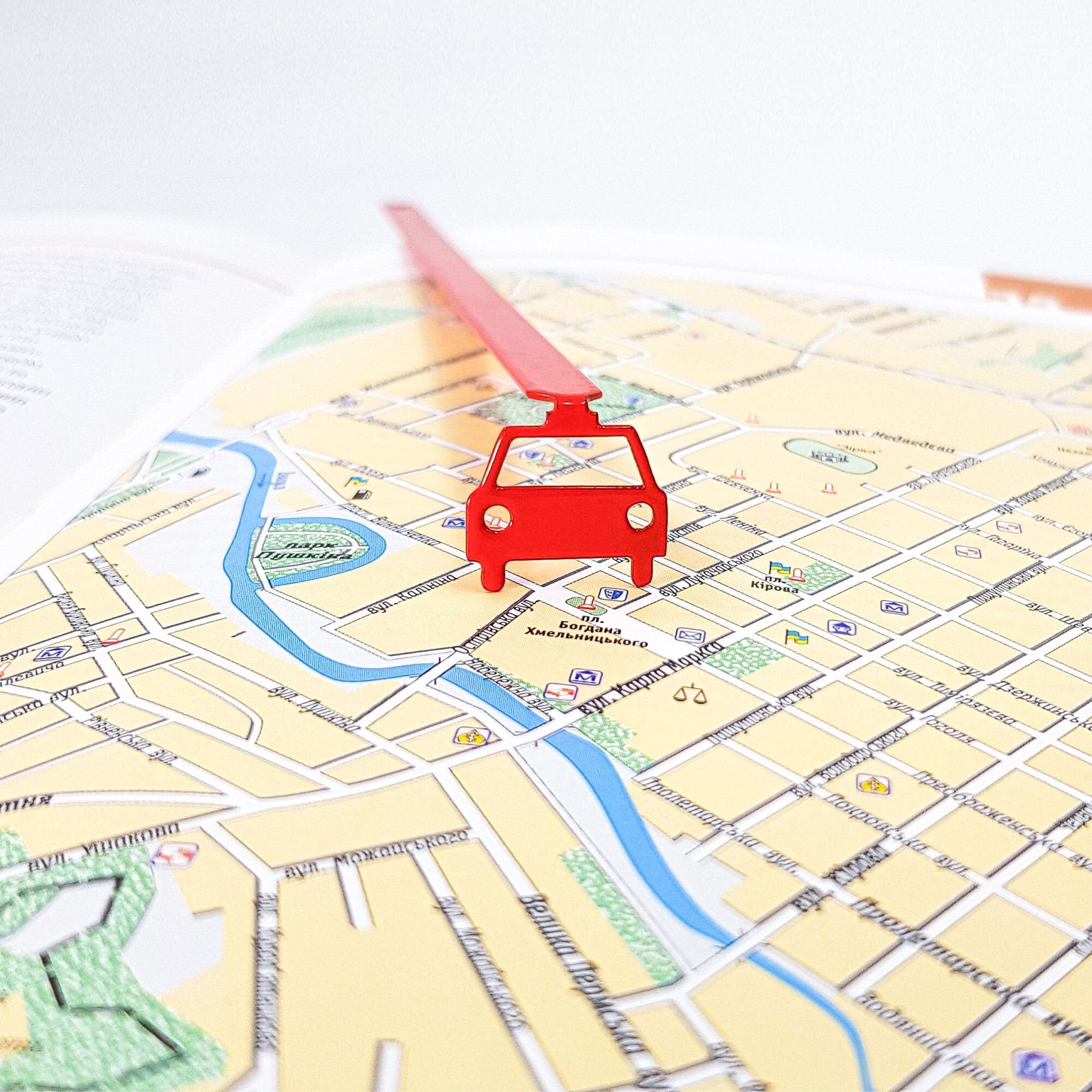 Car metal bookmark in red on a coloured background