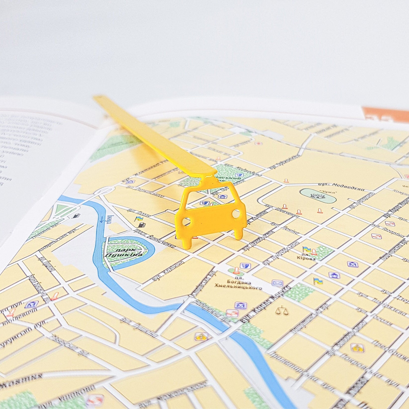 Car metal bookmark in gold against a coloured backdrop
