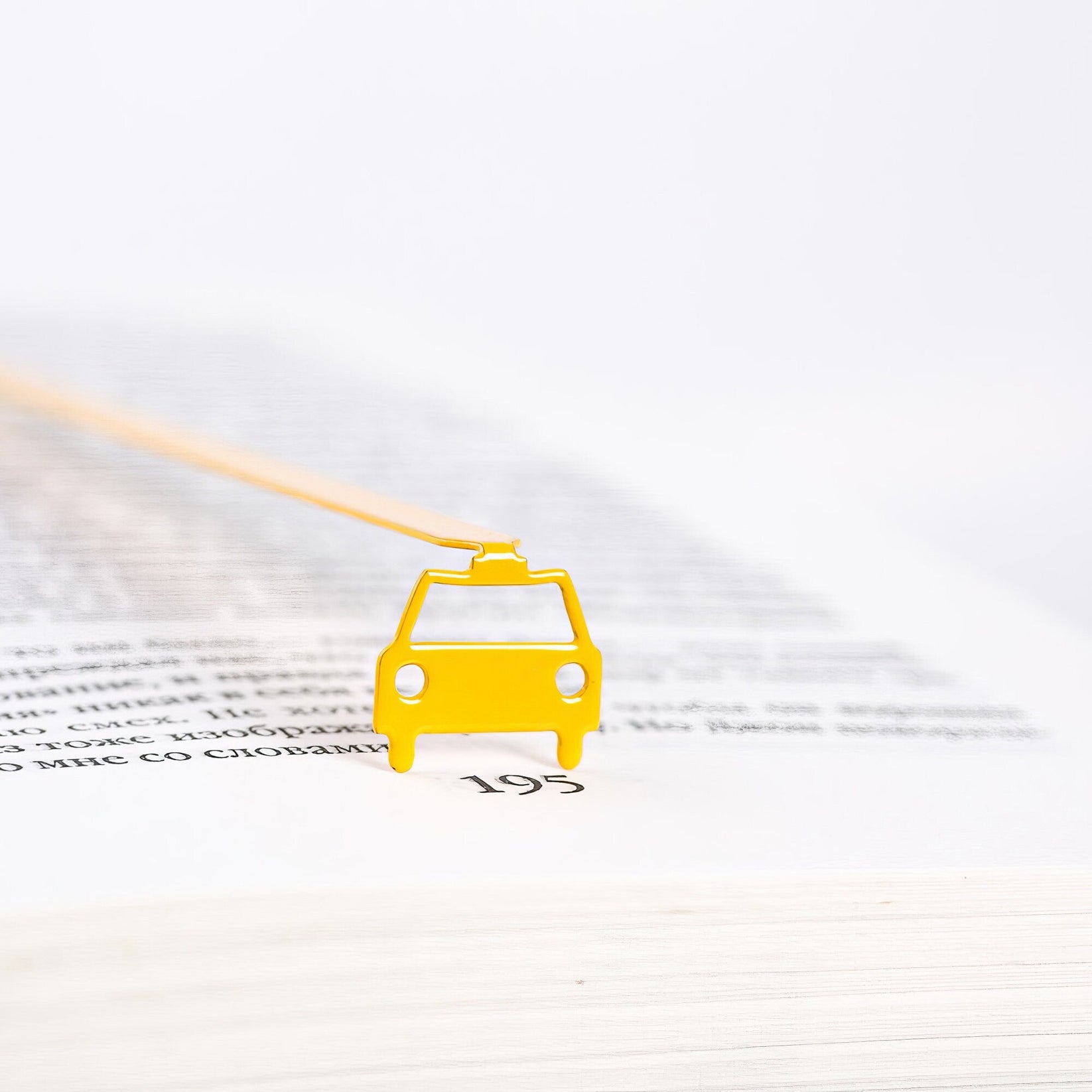 Car metal bookmark in gold shown flat on a white background