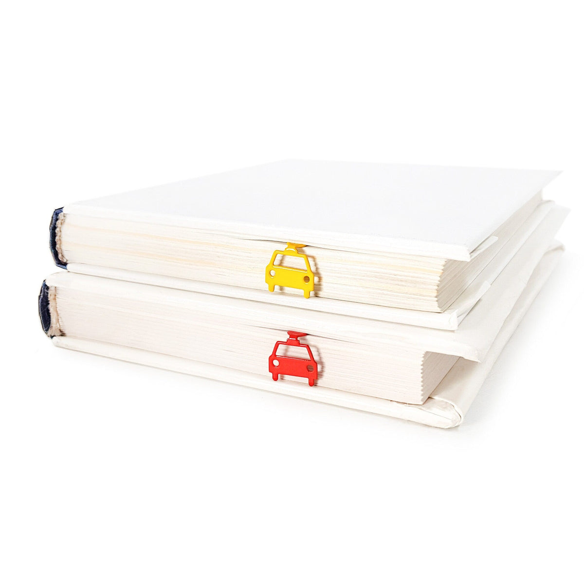 Car metal bookmark in gold shown with a stack of books