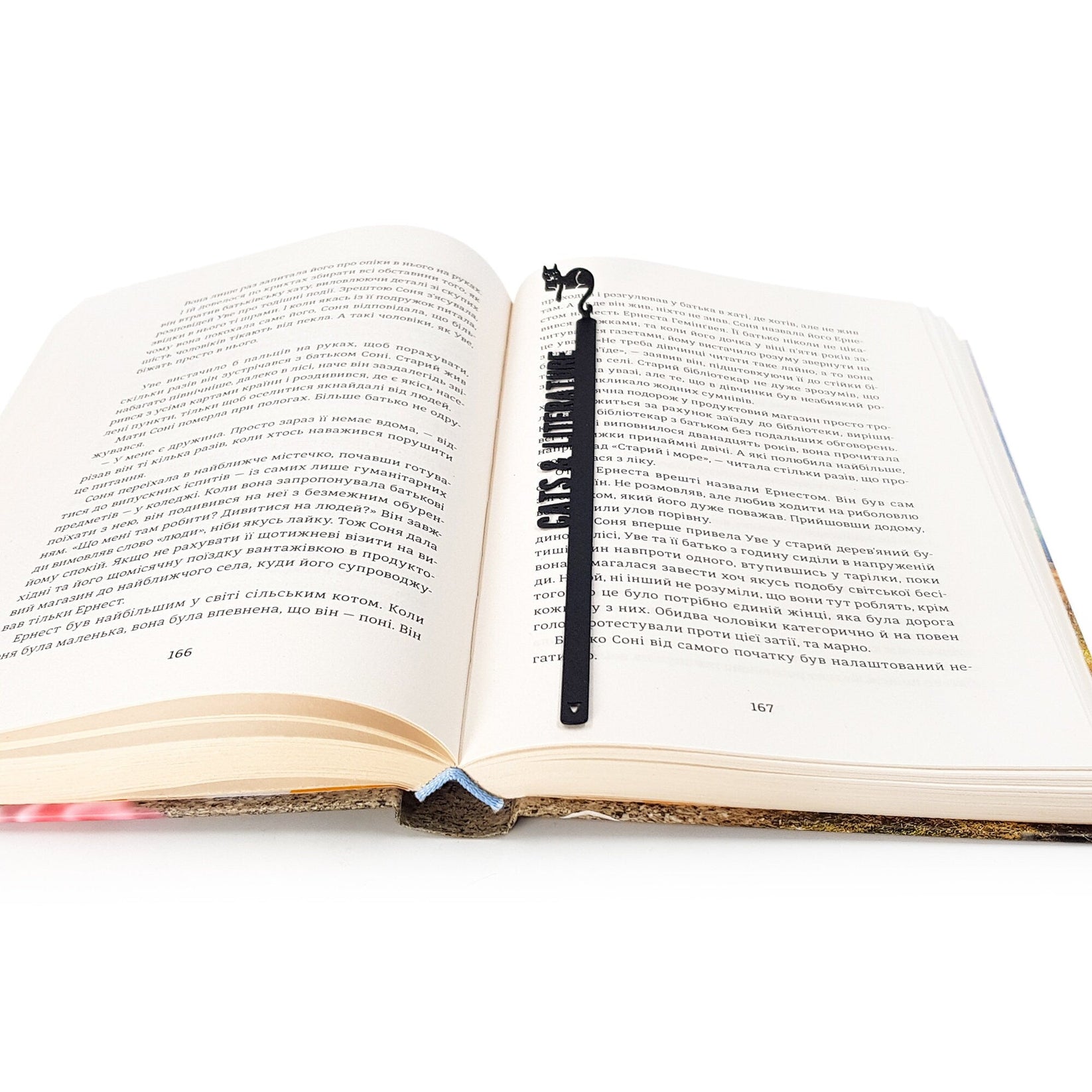Cats and Literature metal bookmark lying across the pages of an open book