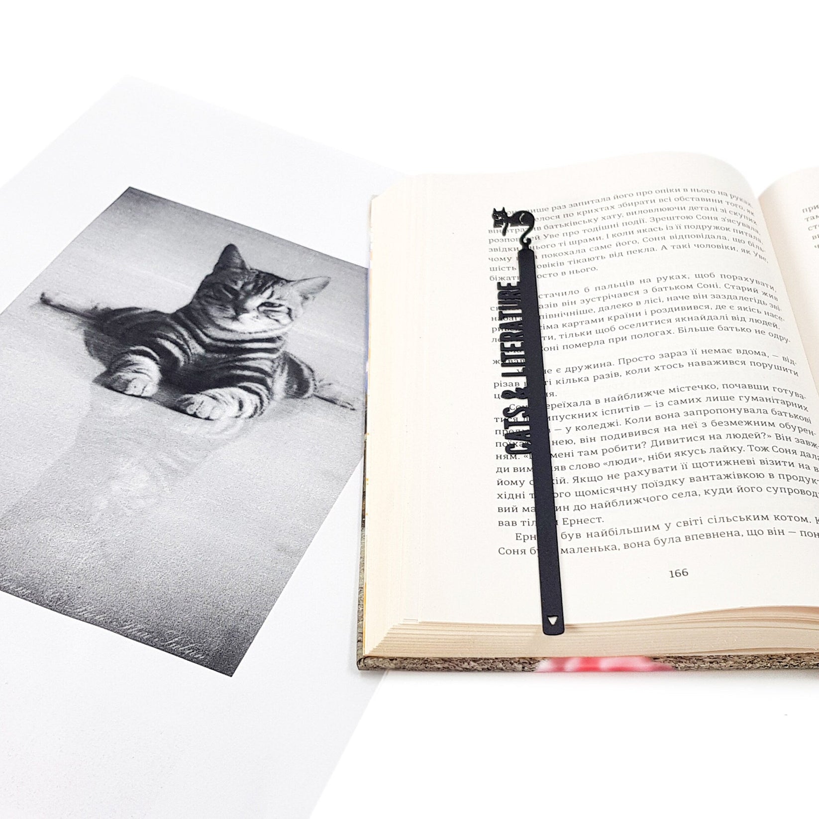 Cats and Literature metal bookmark marking a page in an illustrated book