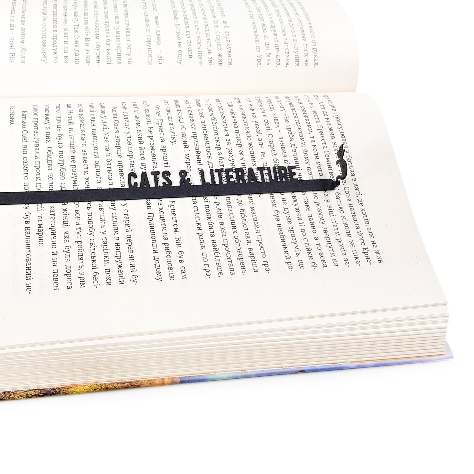Cats and Literature metal bookmark resting on the pages of an open book, view 5