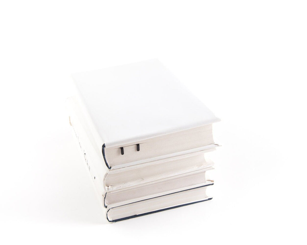 Cats on the Ladder metal bookmark shown with a stack of books