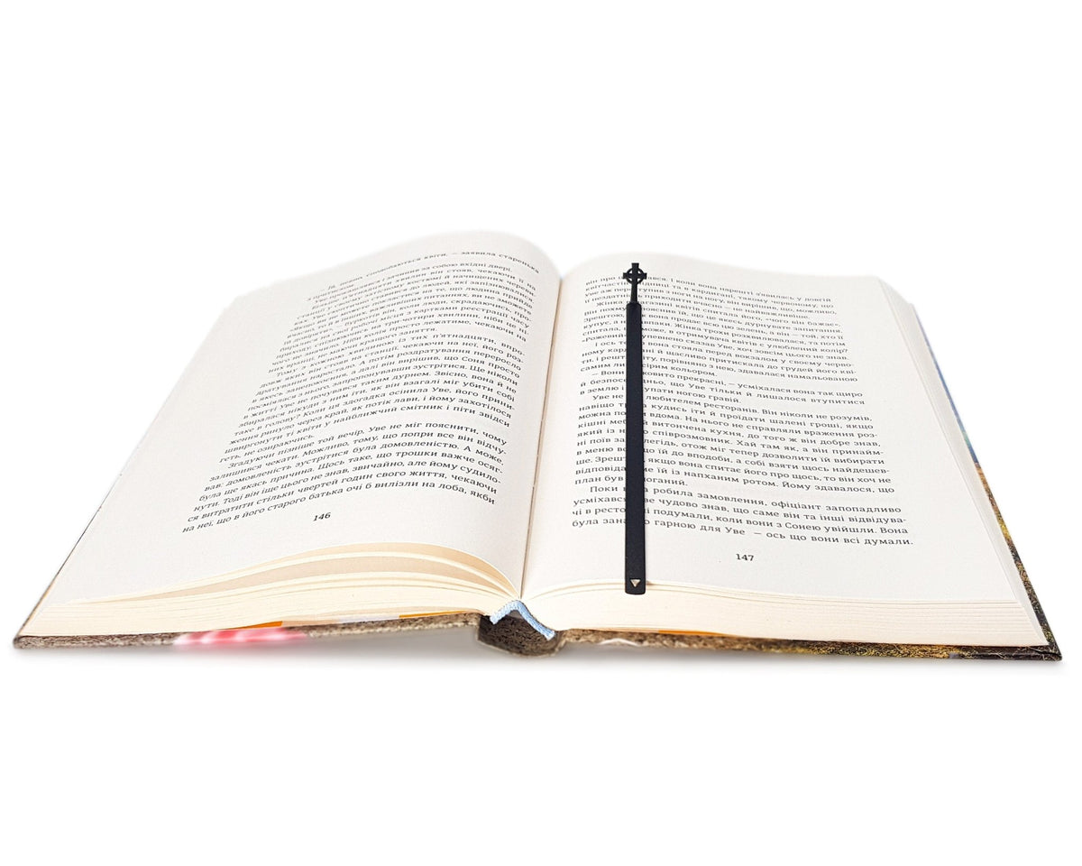 Celtic Cross metal bookmark marking a page in an open book