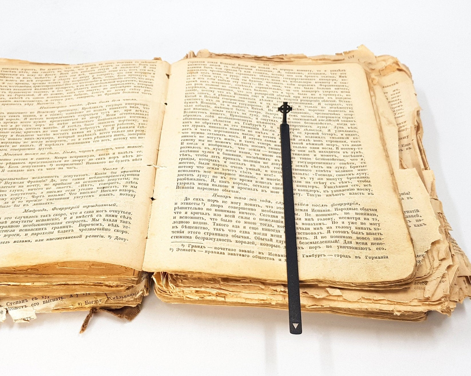 Celtic Cross metal bookmark resting on the pages of an open book