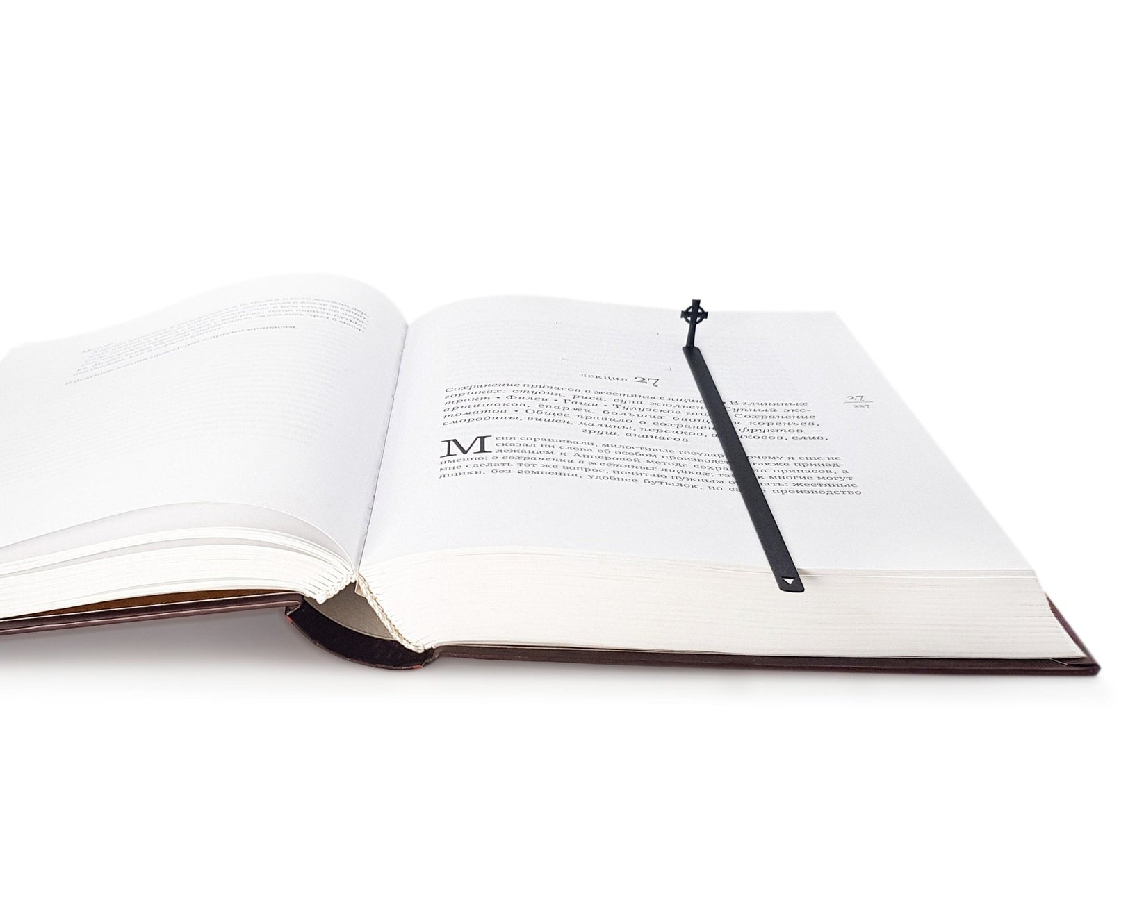 Celtic Cross metal bookmark lying across the pages of an open book