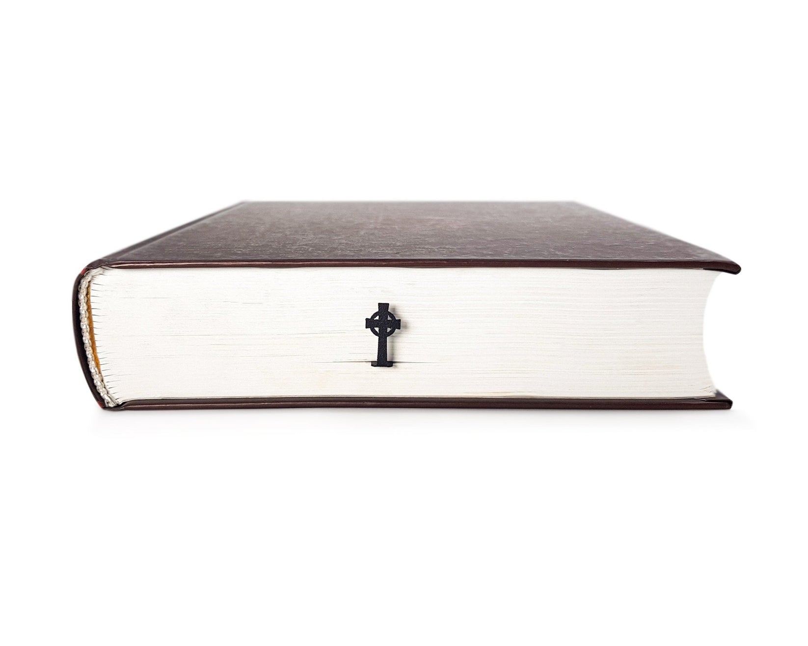 Celtic Cross metal bookmark seen from the edge of a closed book