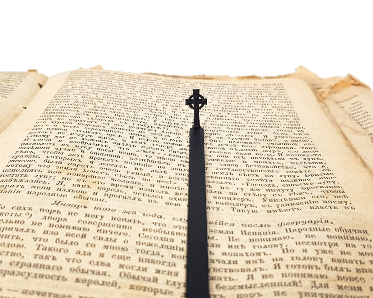 Celtic Cross metal bookmark set into the gutter of an open book