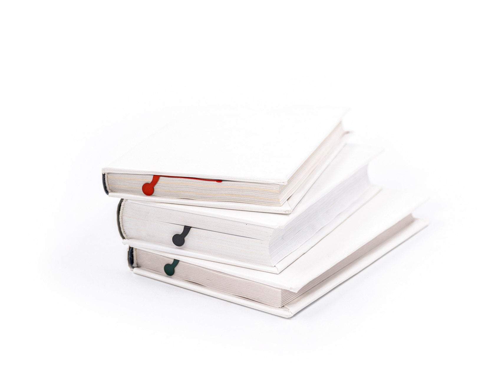 Charming Centipede metal bookmark in red shown with a stack of books