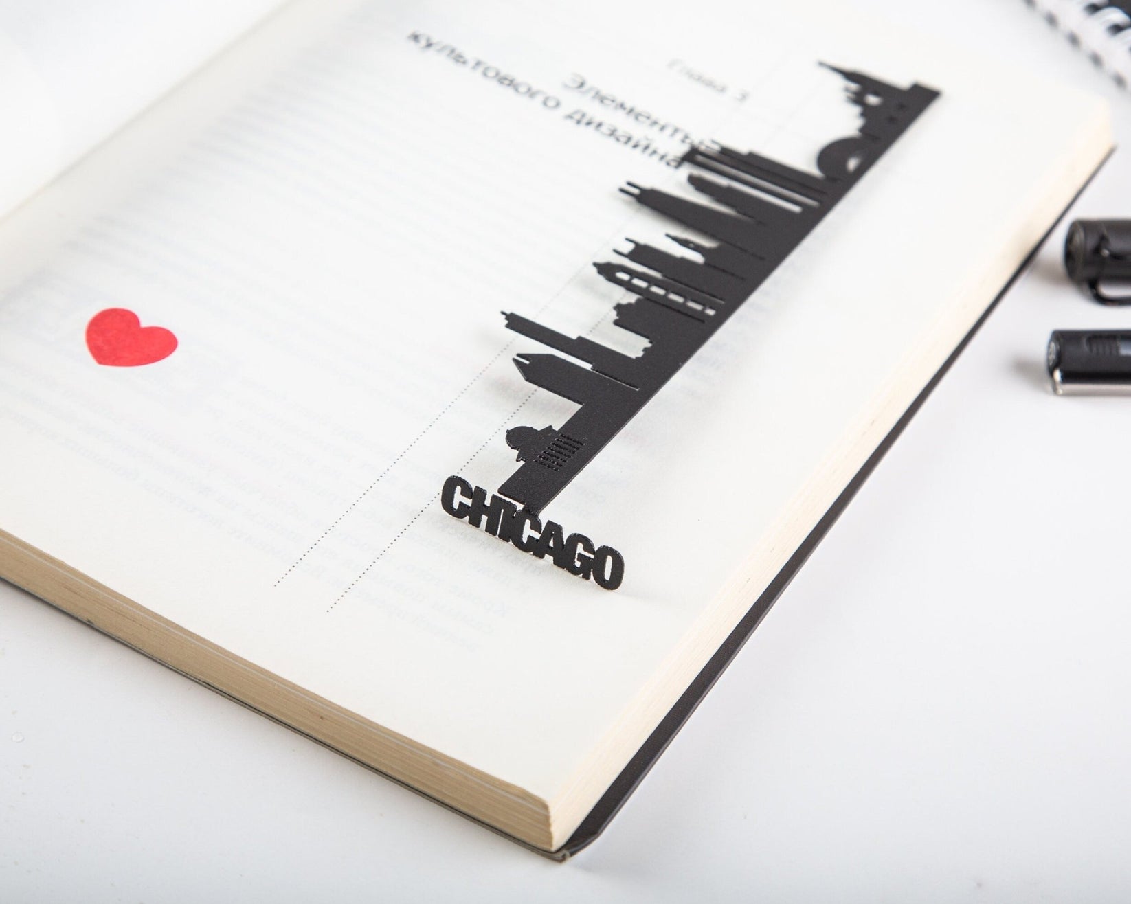 Chicago metal bookmark lying across the pages of an open book