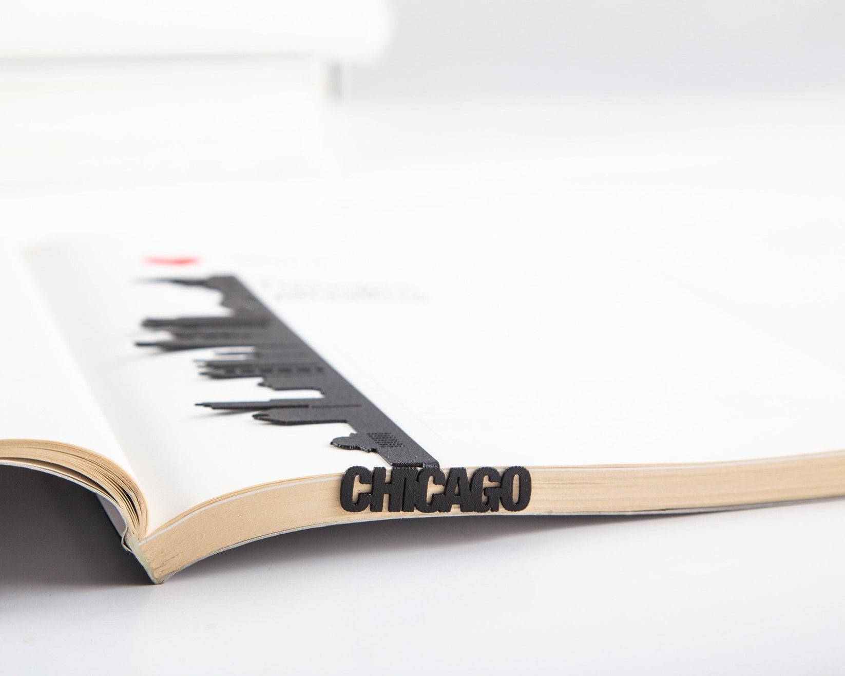 Chicago metal bookmark marking a page in an open book