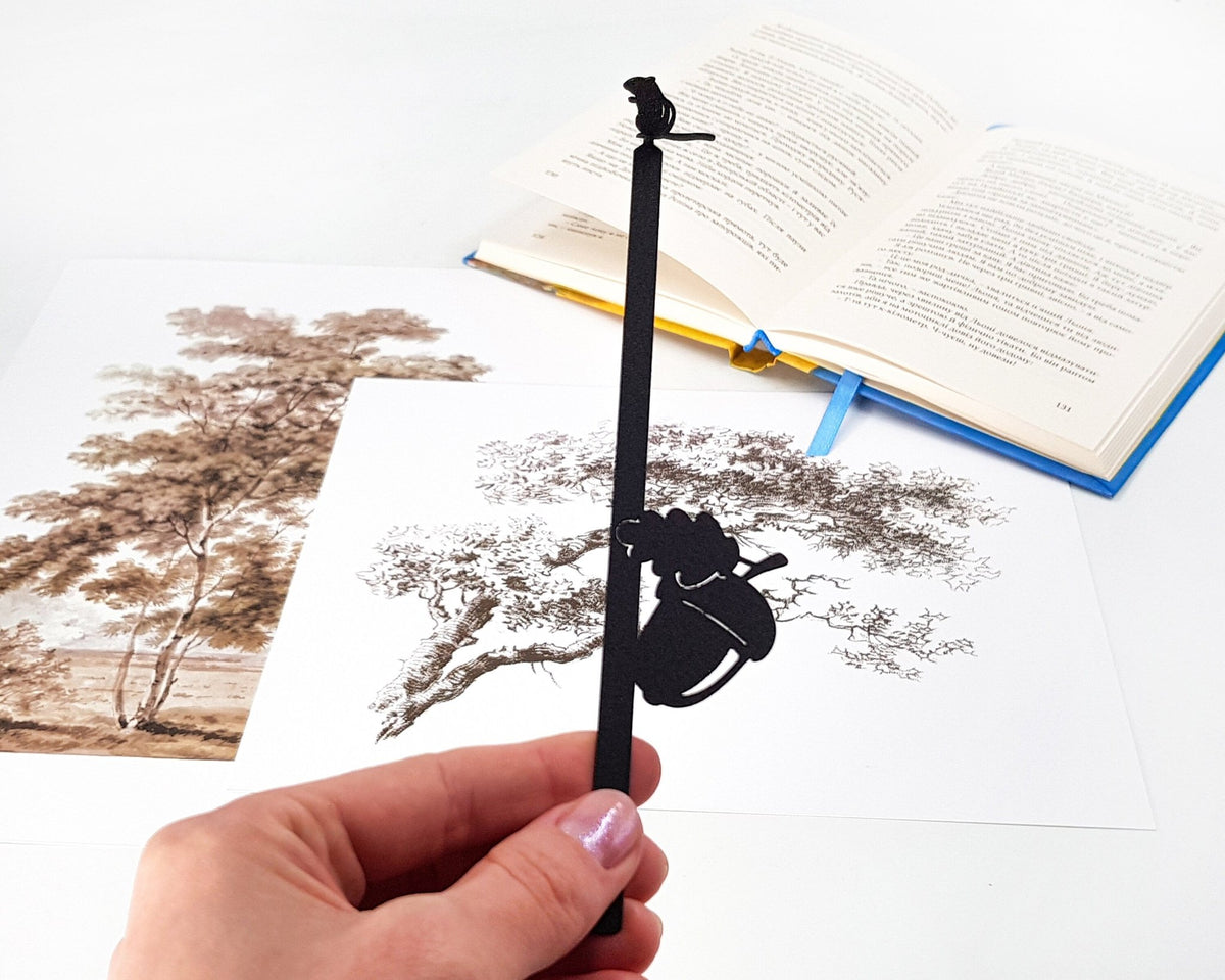Chipmunk and the Acorn metal bookmark on an illustrated page