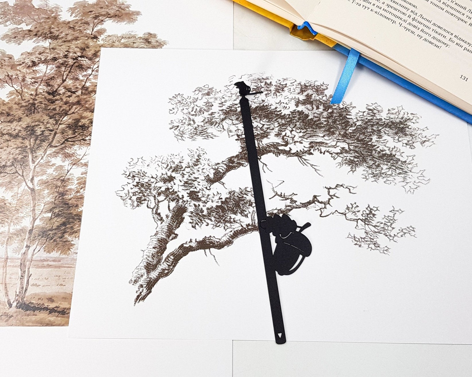 Chipmunk and the Acorn metal bookmark marking a page in an illustrated book