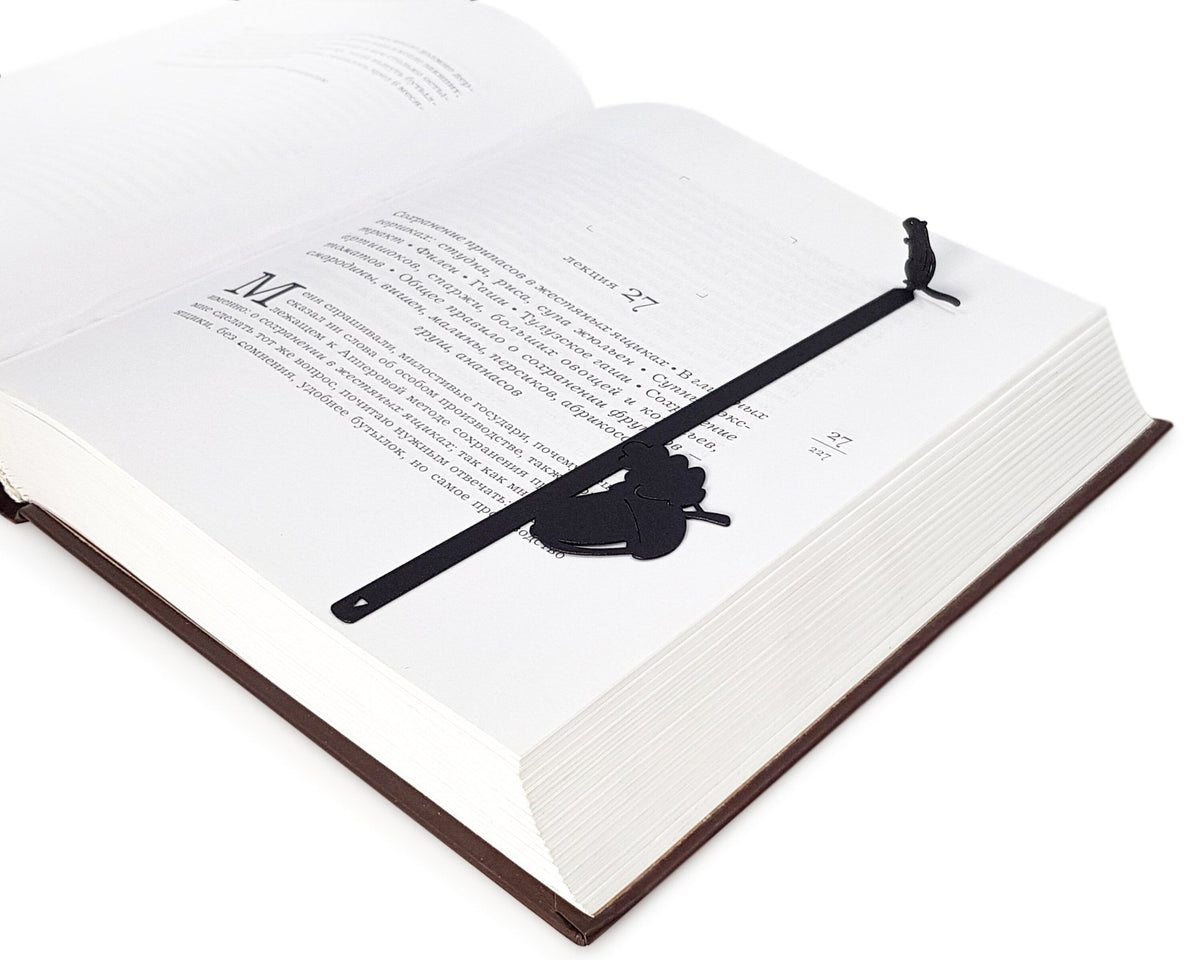 Chipmunk and the Acorn metal bookmark marking a page in an open book