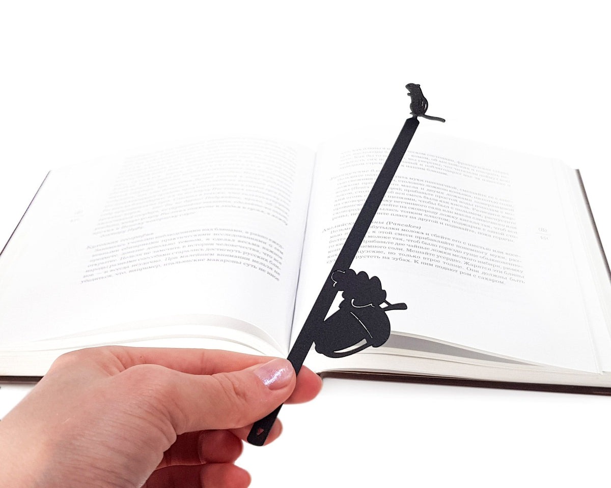 Chipmunk and the Acorn metal bookmark held up beside an open book