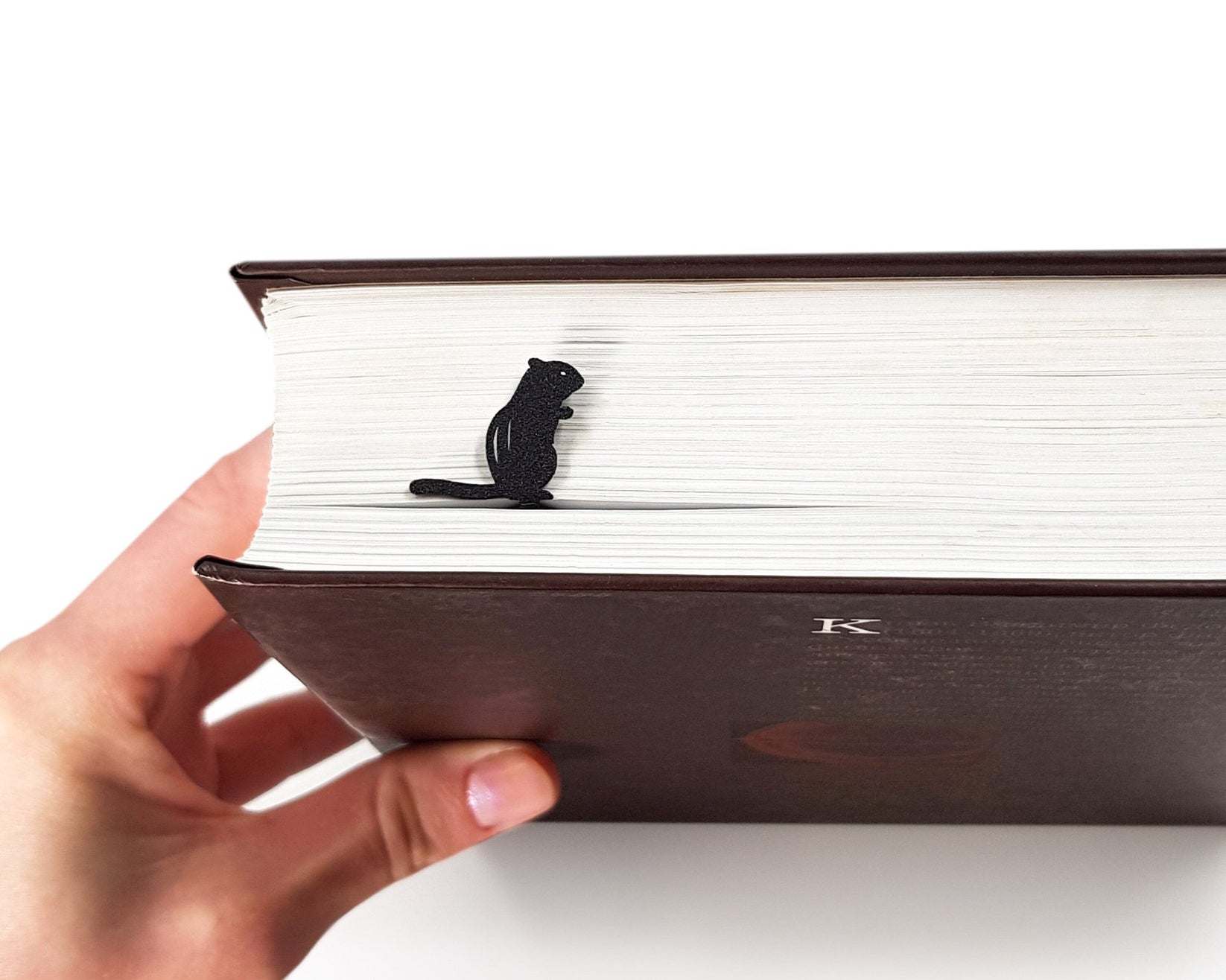 Chipmunk and the Acorn metal bookmark held in a hand to show its size