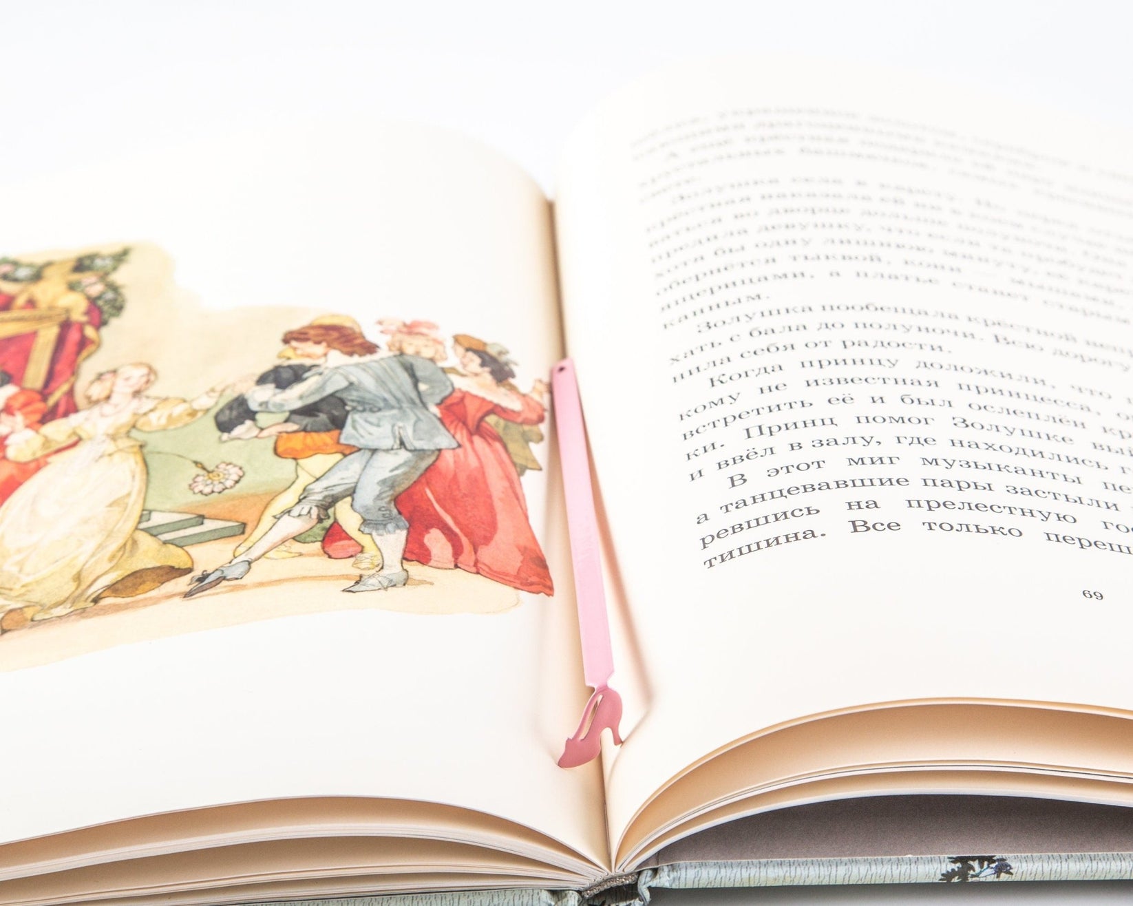 Cinderella's Slipper metal bookmark in red marking a page in an illustrated book, view 4