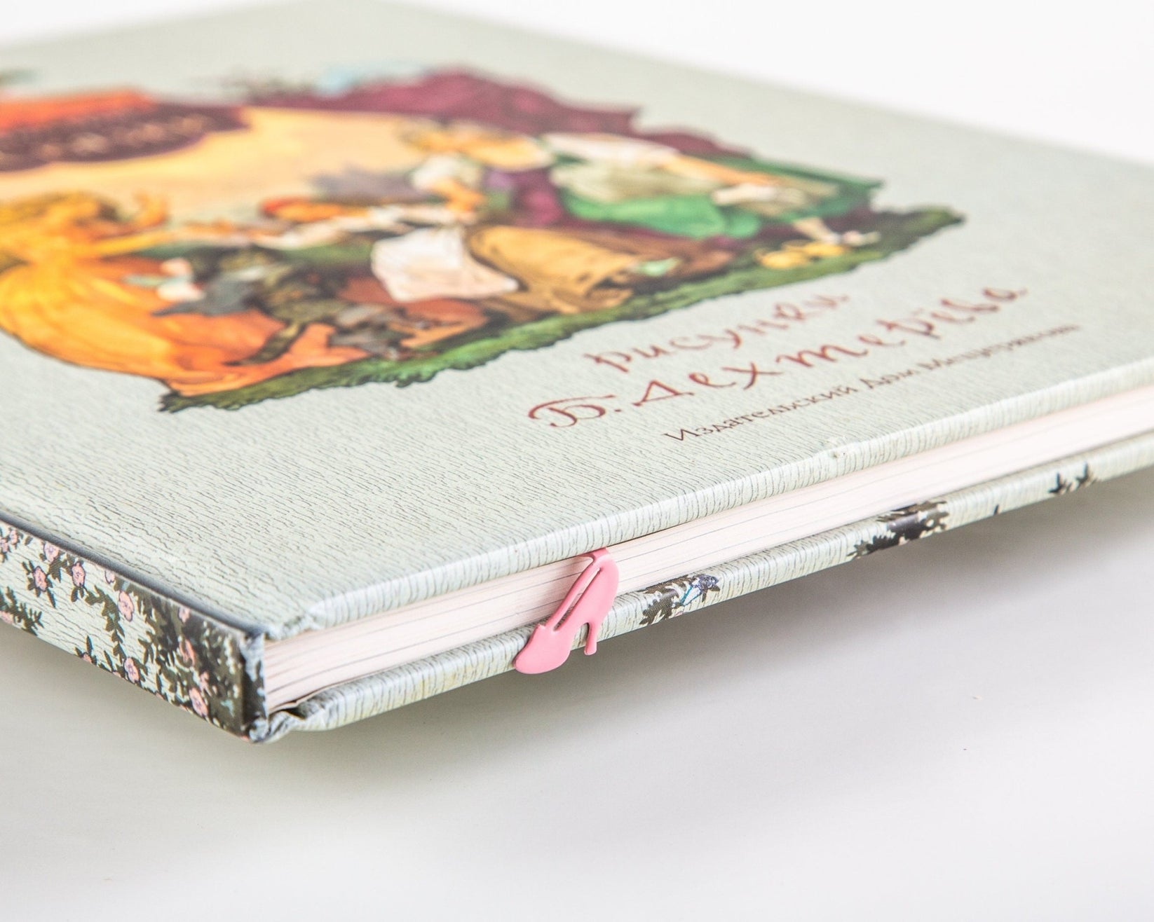 Cinderella's Slipper metal bookmark in red on an illustrated page