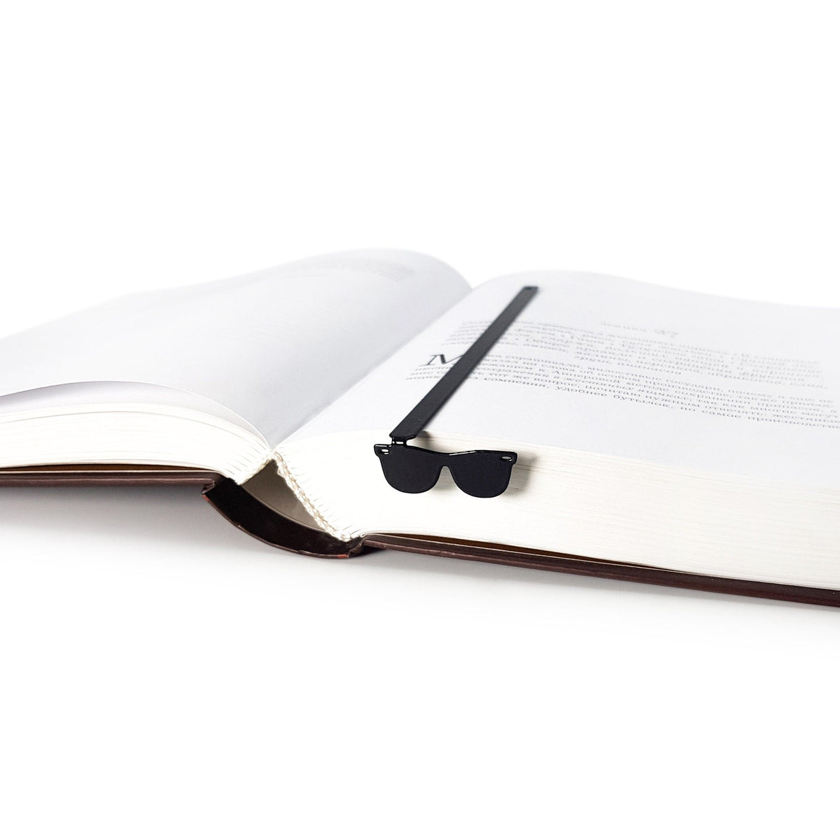 Cool Sunglasses metal bookmark seen from the edge of a closed book