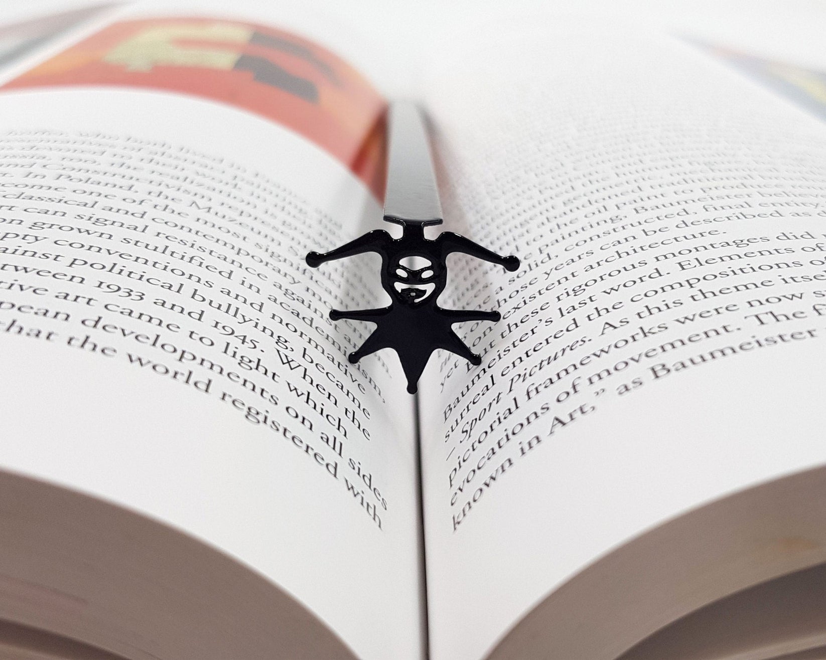 Court Jester metal bookmark resting on the pages of an open book