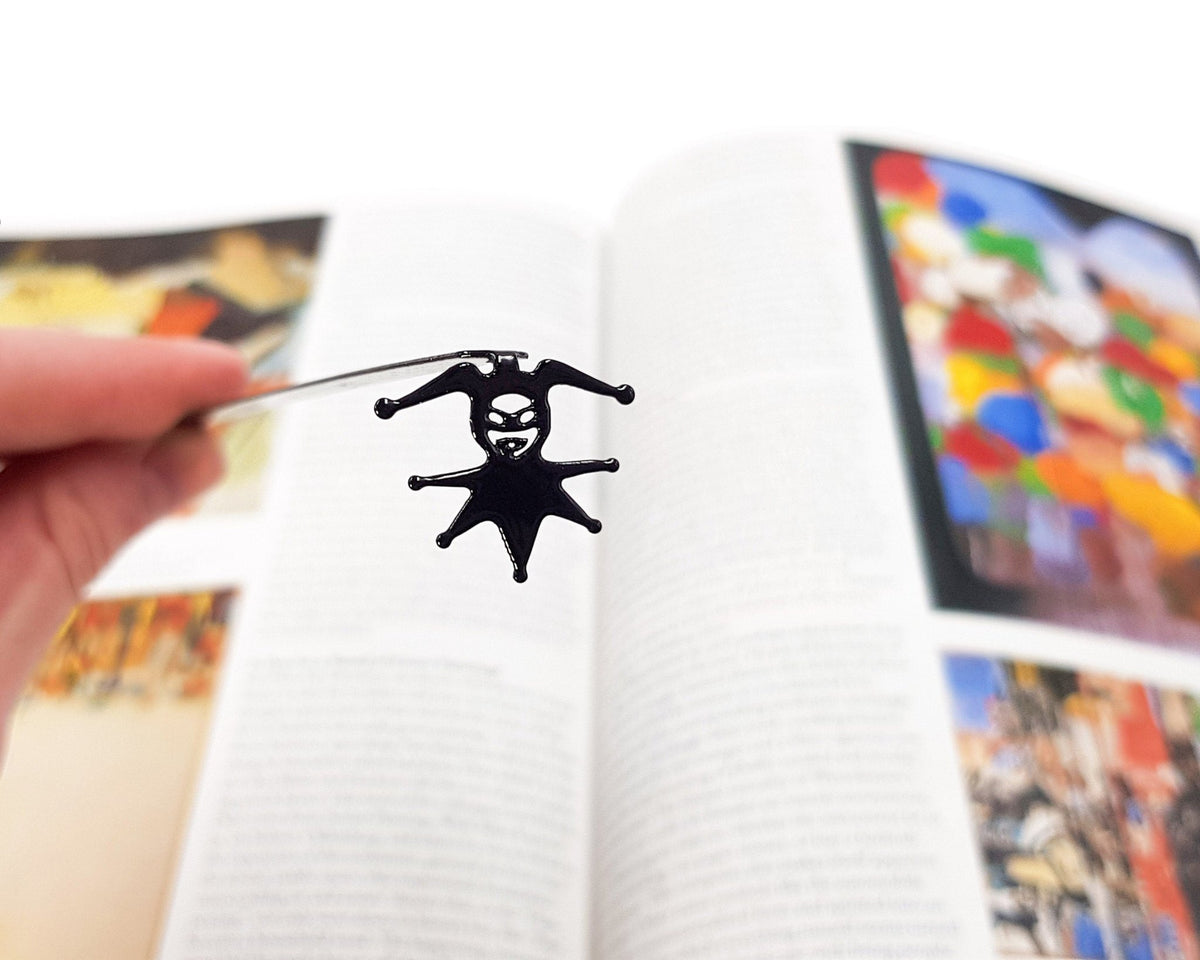 Court Jester metal bookmark on an illustrated page