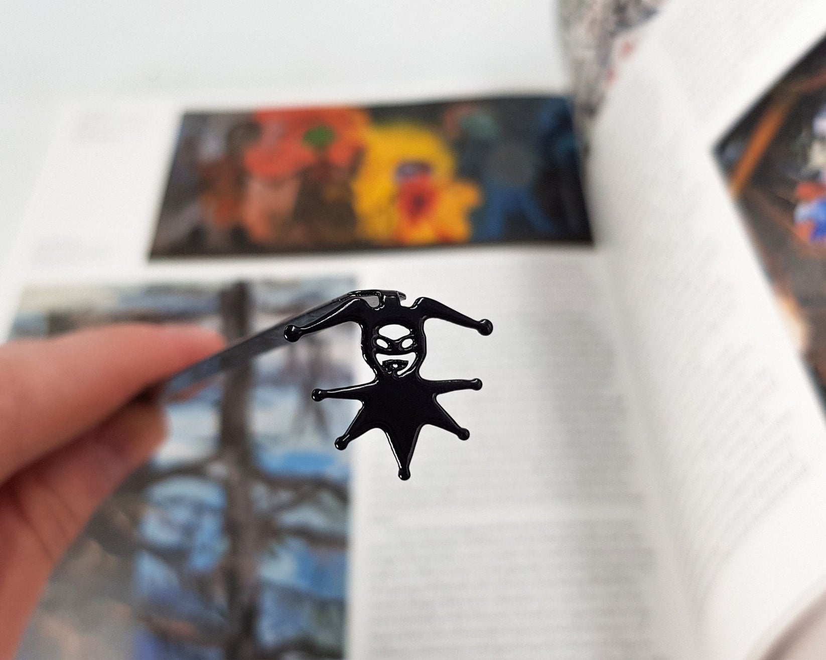 Court Jester metal bookmark marking a page in an illustrated book