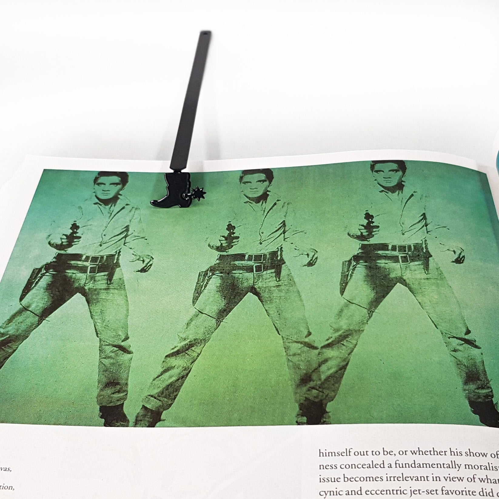 Cowboy's Boot metal bookmark on an illustrated page