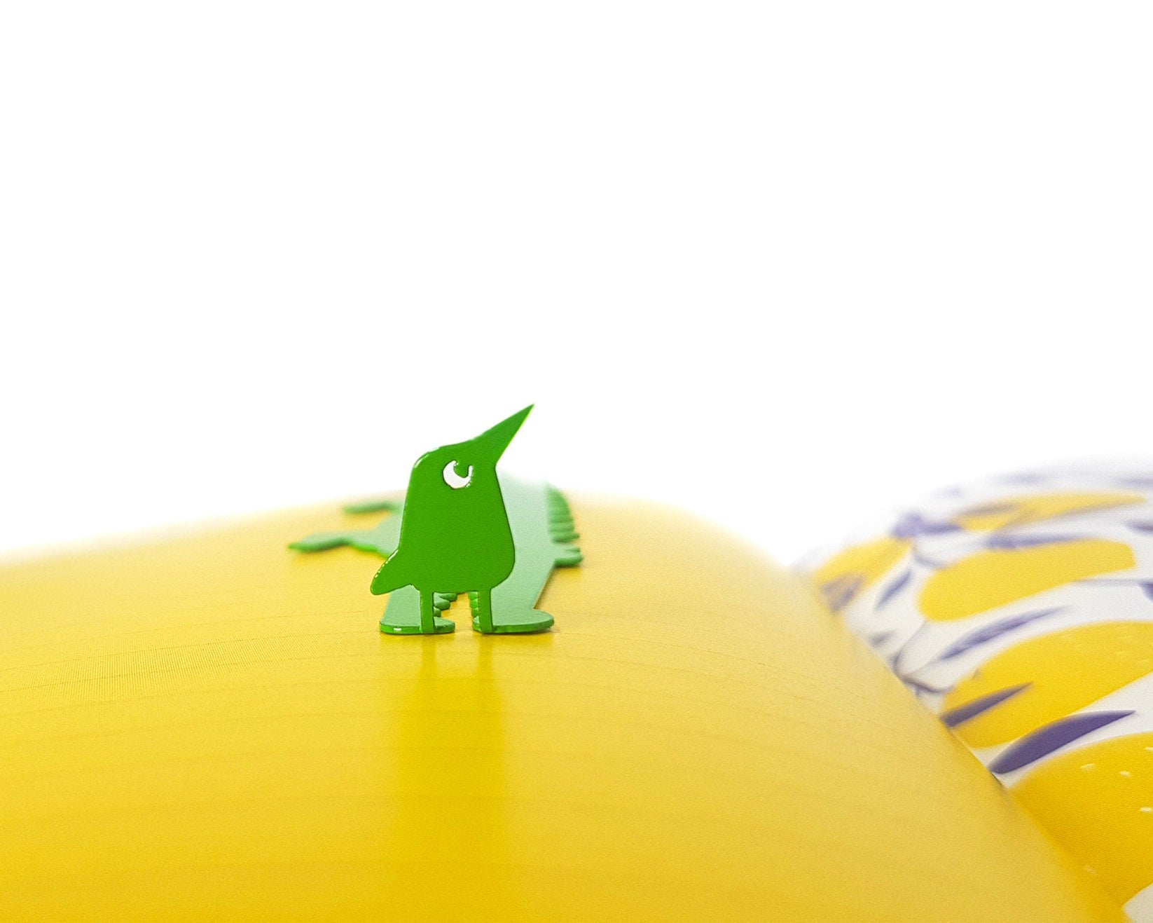 Crocodile and the Nile Bird metal bookmark in green against a coloured backdrop