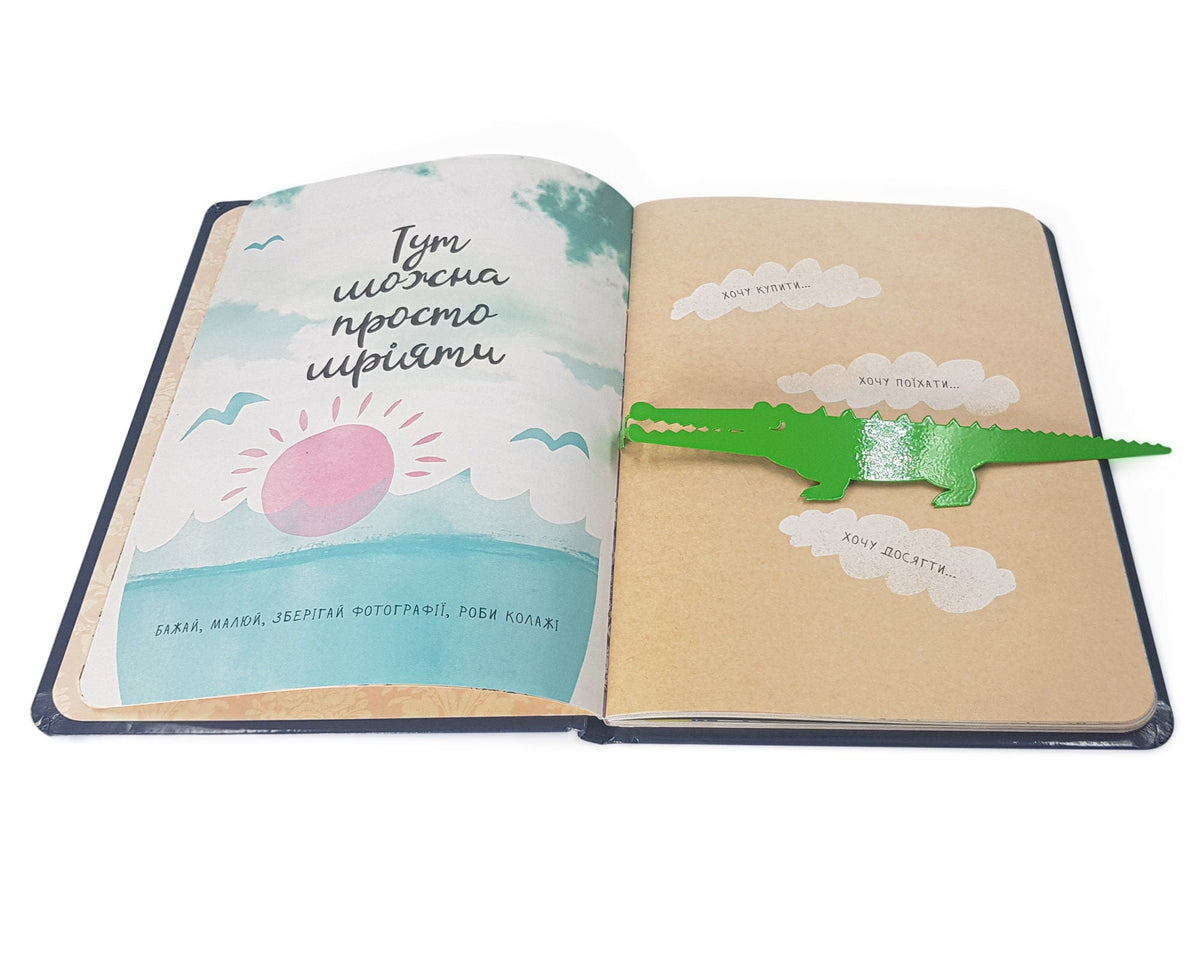 Crocodile and the Nile Bird metal bookmark in green marking a page in an illustrated book