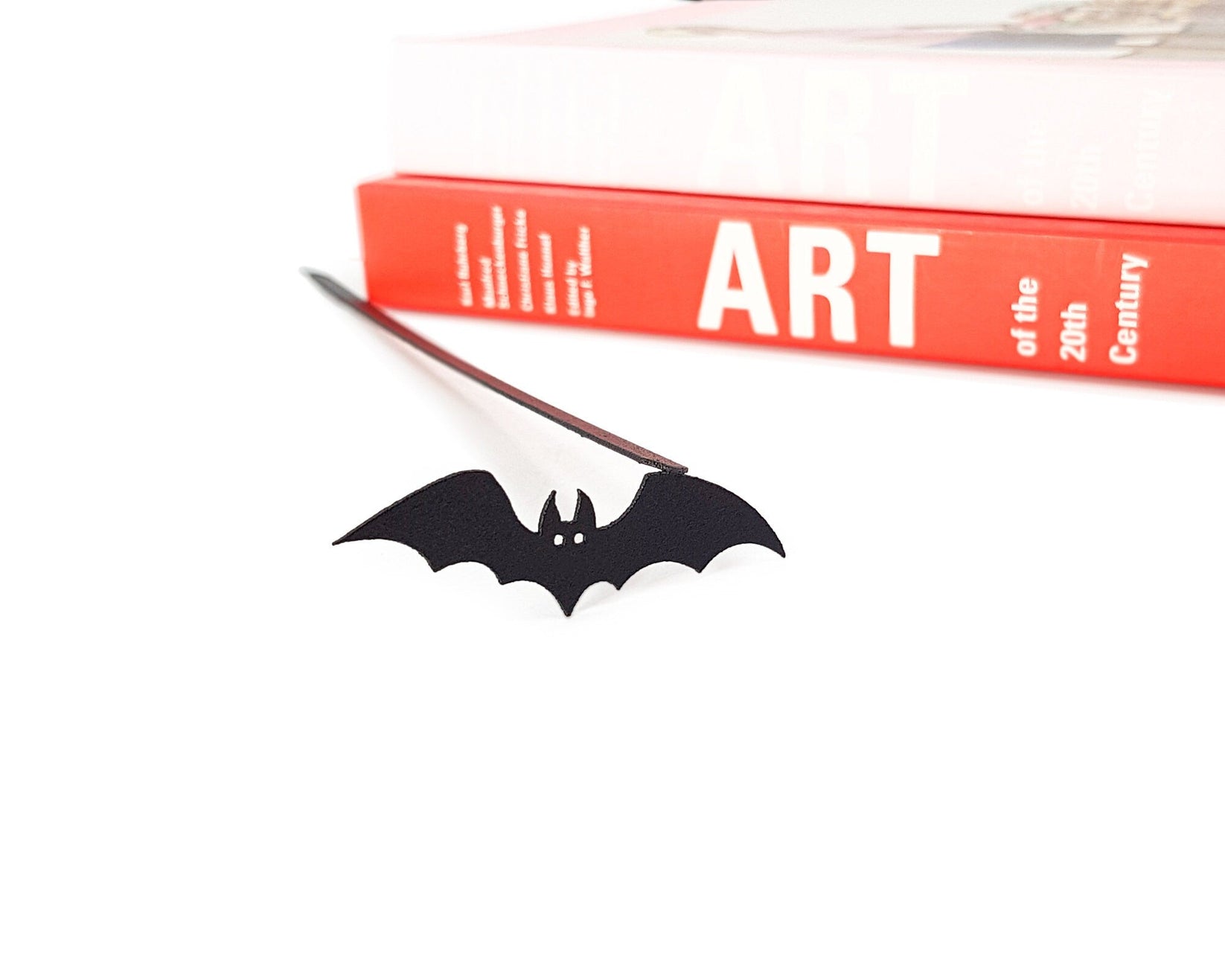 Cryptic Bat metal bookmark on a coloured background