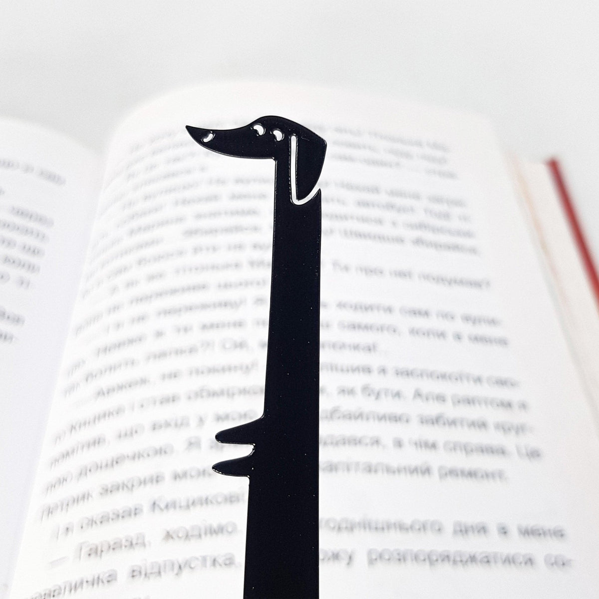 Dachshund My Long Time Friend metal bookmark resting on the pages of an open book