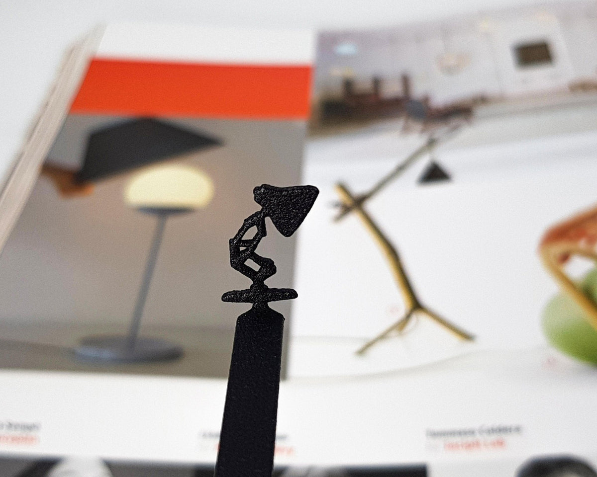 Desk Lamp metal bookmark marking a page in an illustrated book