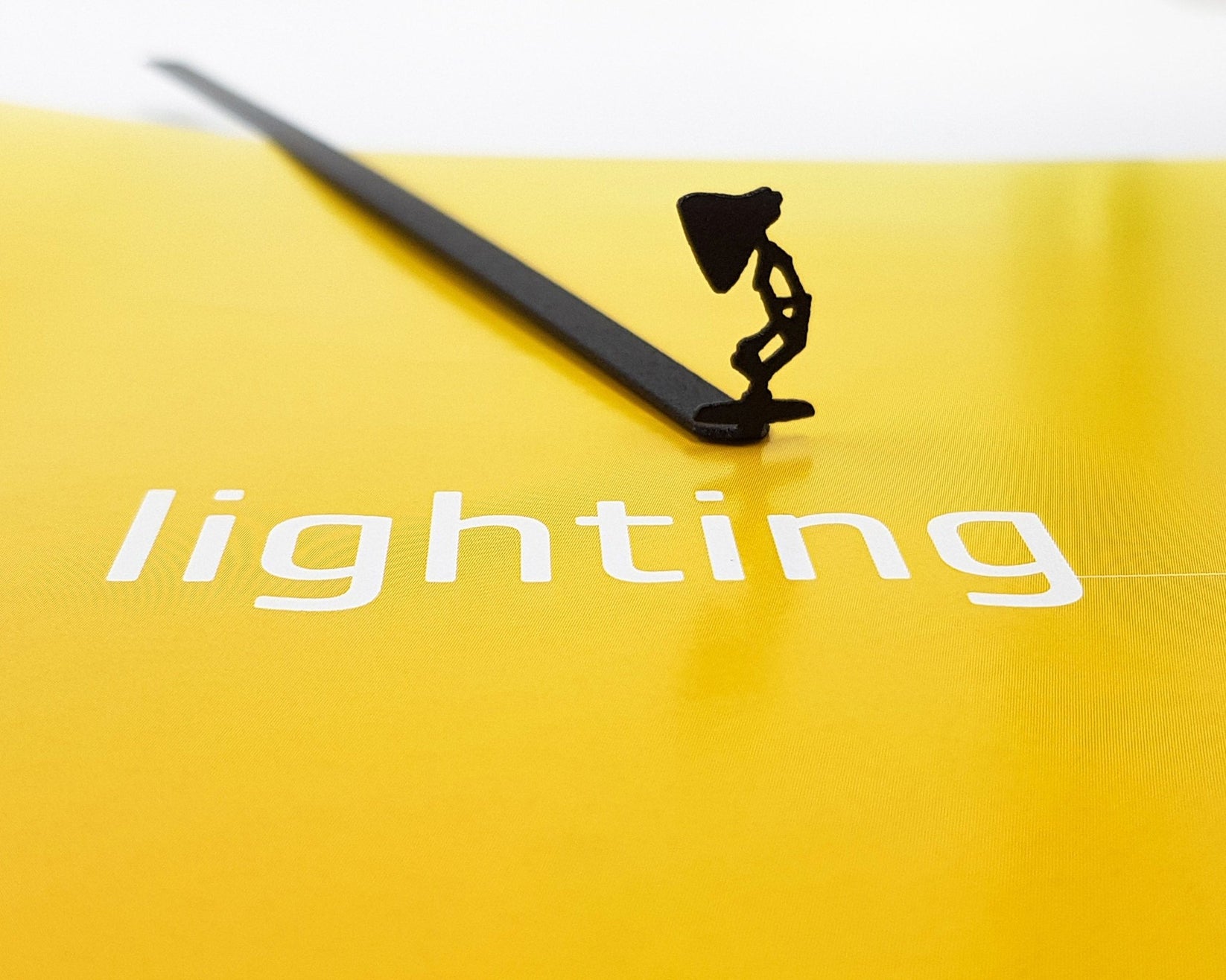 Desk Lamp metal bookmark on a coloured background