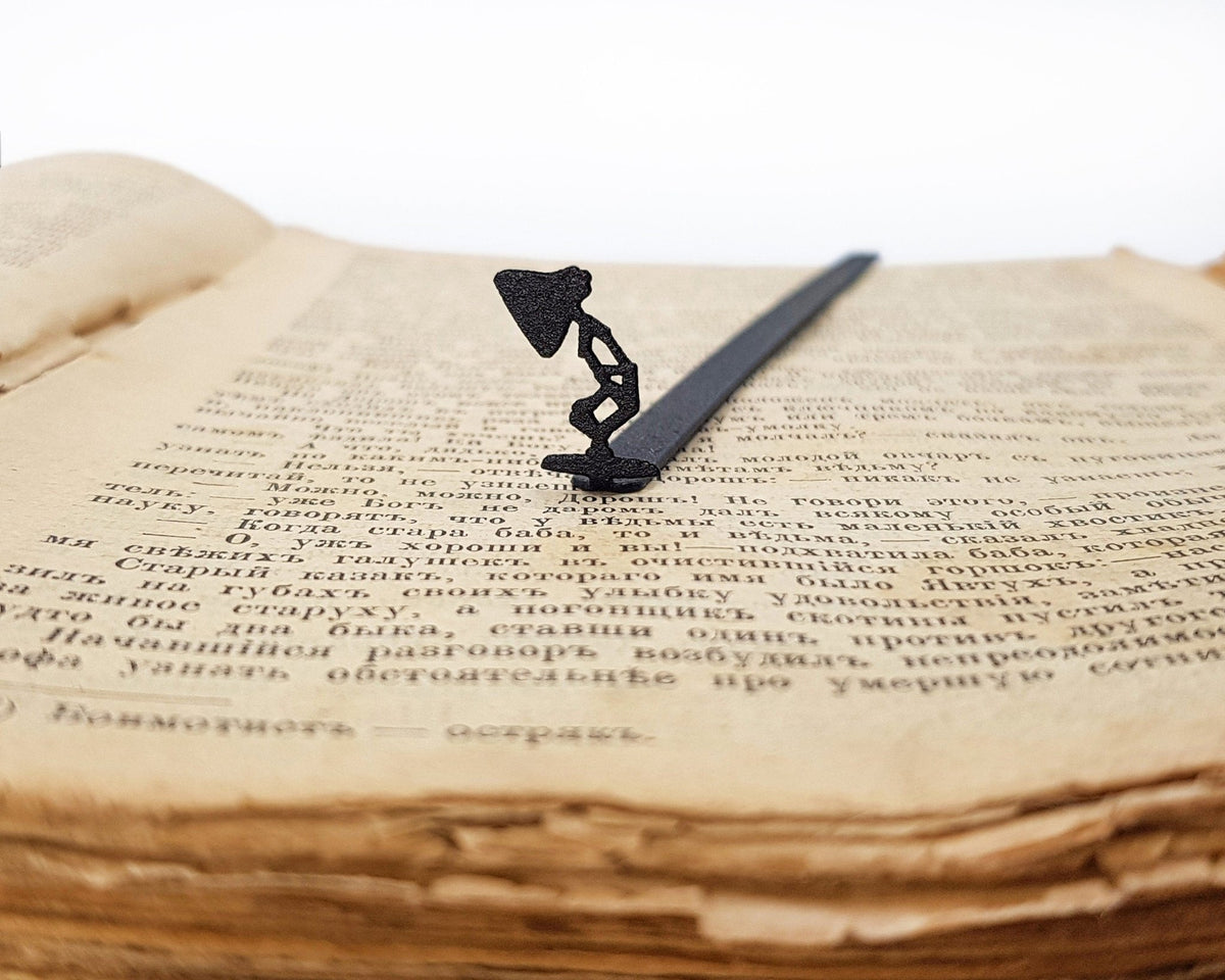 Desk Lamp metal bookmark resting on the pages of an open book