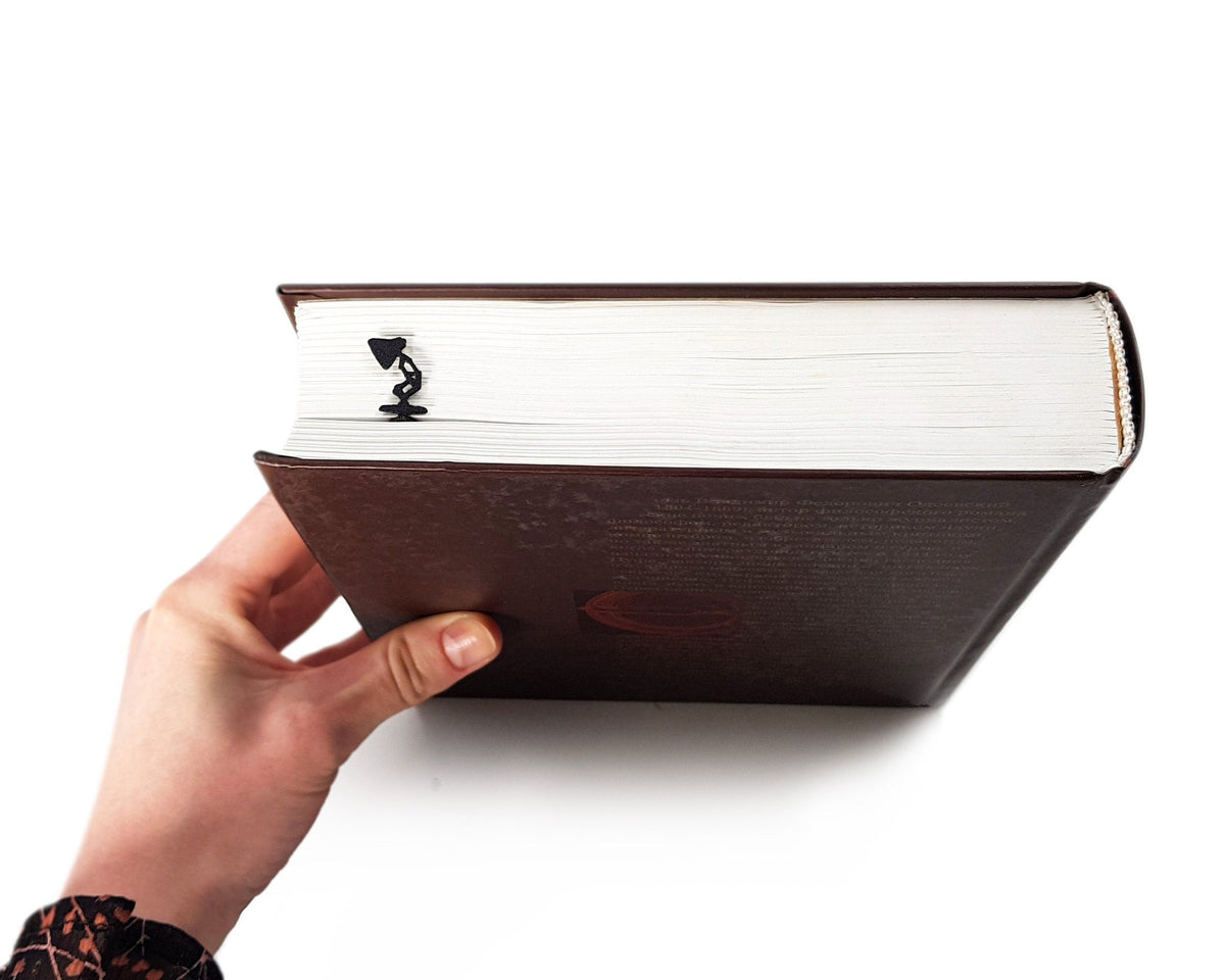 Desk Lamp metal bookmark in a closed book, only its top showing above the pages