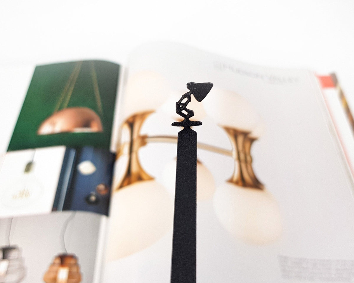 Desk Lamp metal bookmark marking a page in an illustrated book, view 4