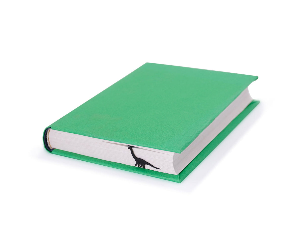 Dinosaur Geometry Style metal bookmark in a closed book, only its top showing above the pages