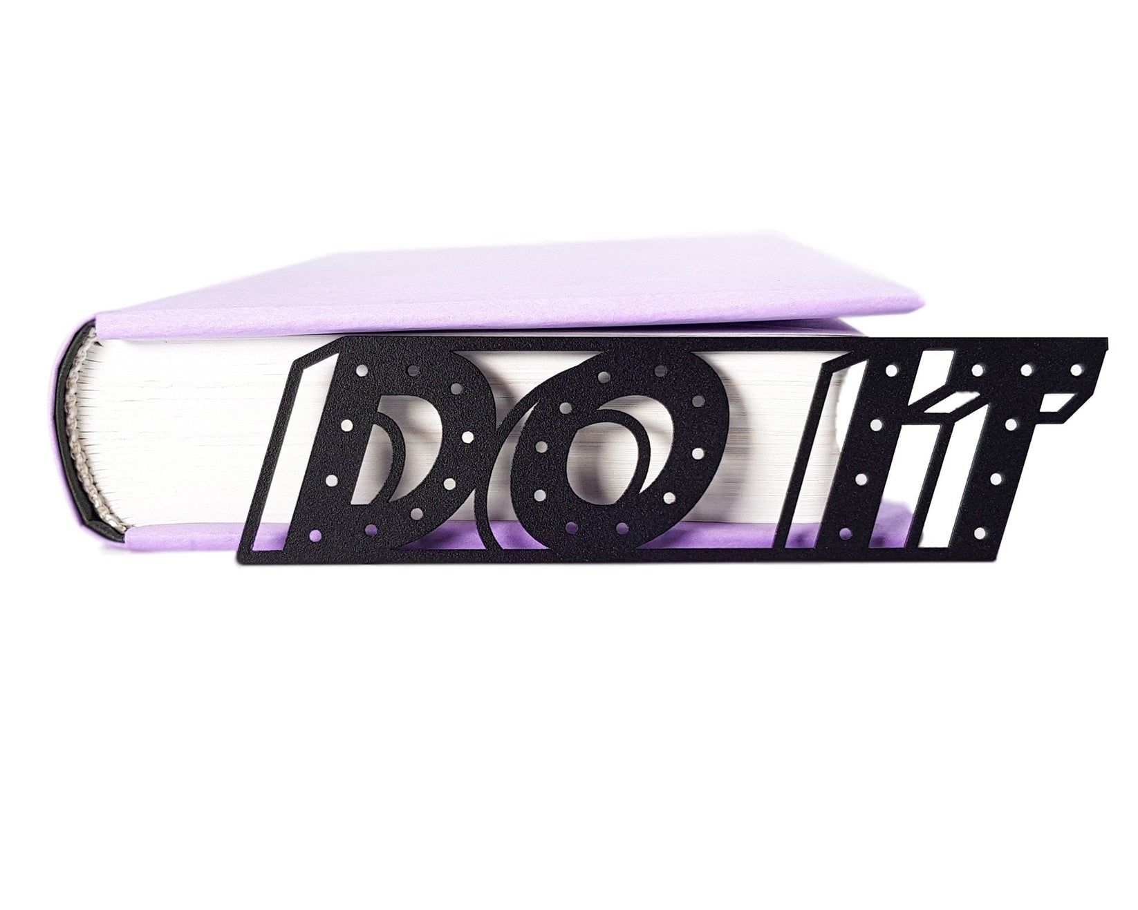 Do It metal bookmark in a closed book, only its top showing above the pages, view 5