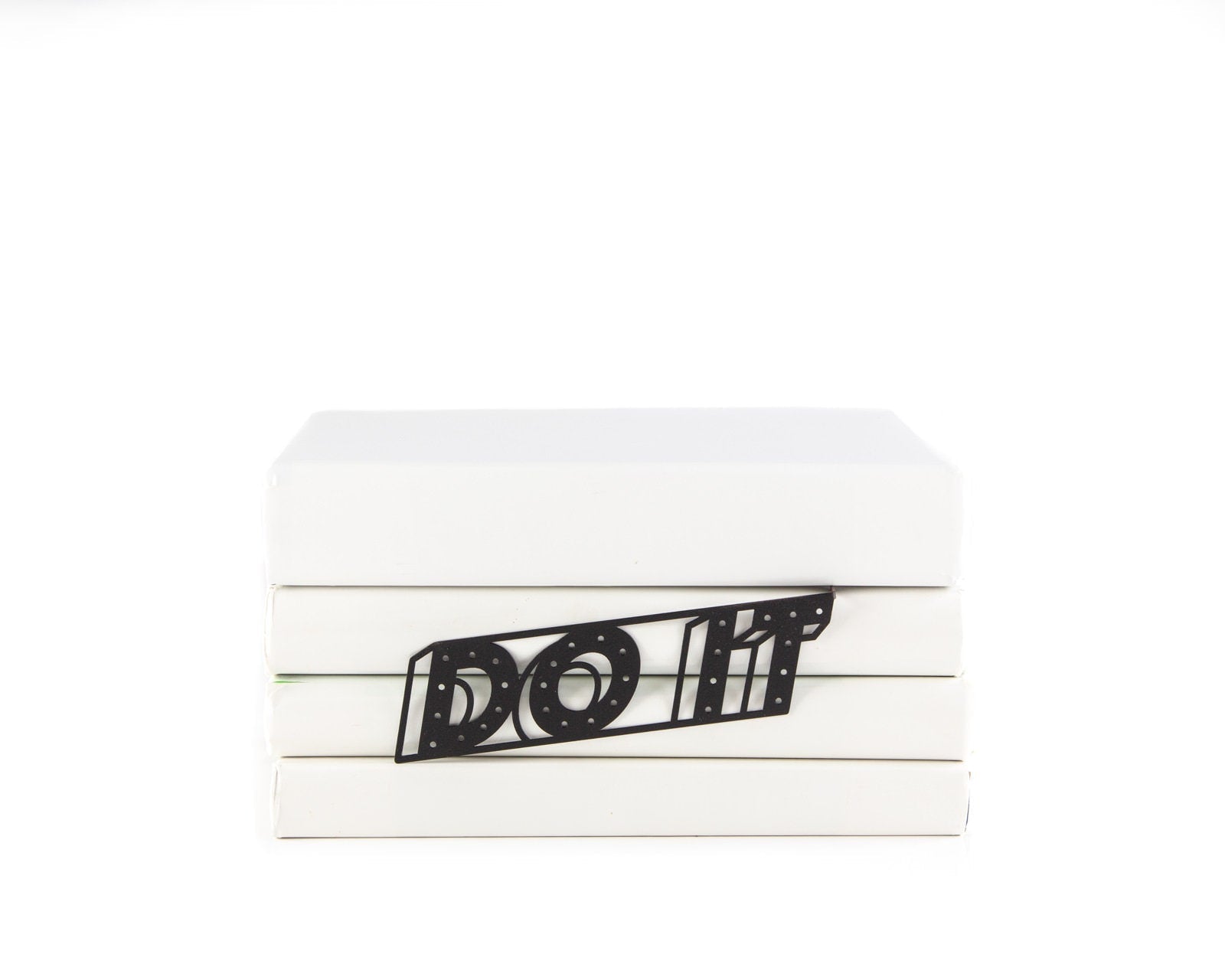 Do It metal bookmark clipped in a closed book, viewed from the side