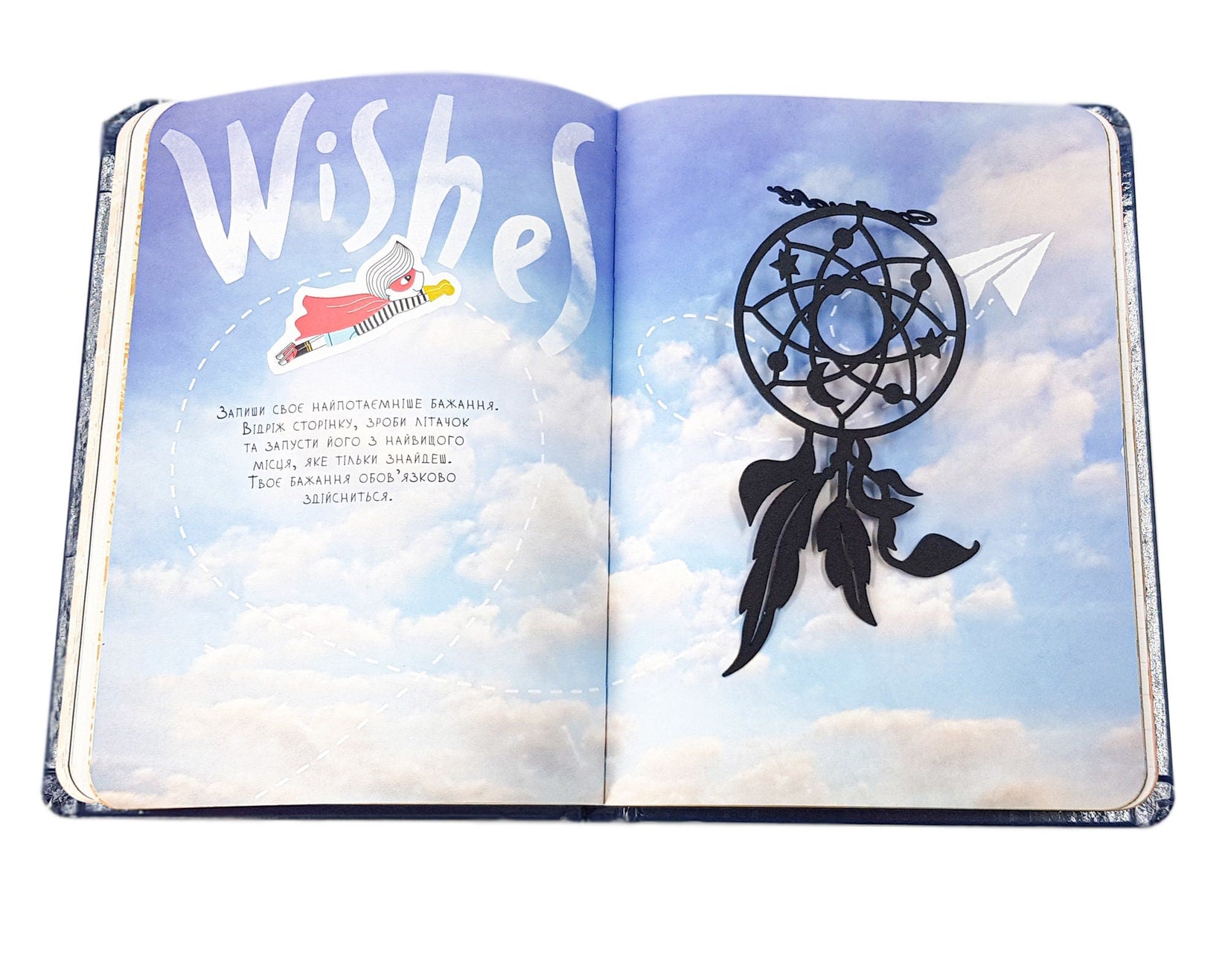Dream Catcher metal bookmark on an illustrated page