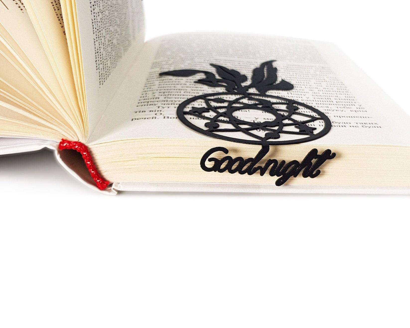 Dream Catcher metal bookmark lying across the pages of an open book