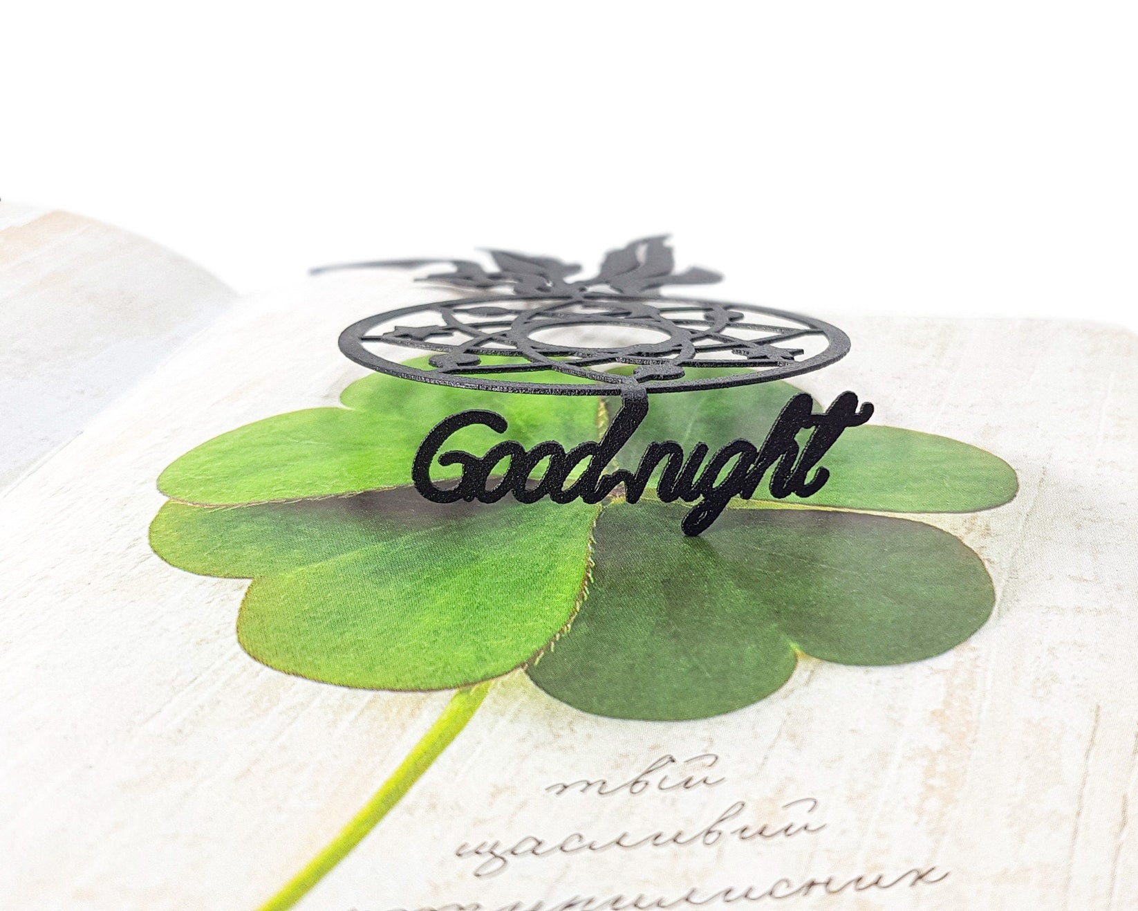Dream Catcher metal bookmark on a coloured background