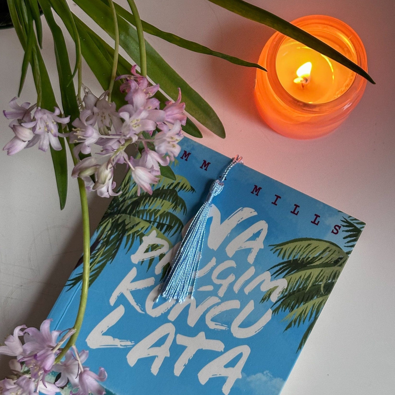 Dreamer metal bookmark shown with a stack of books