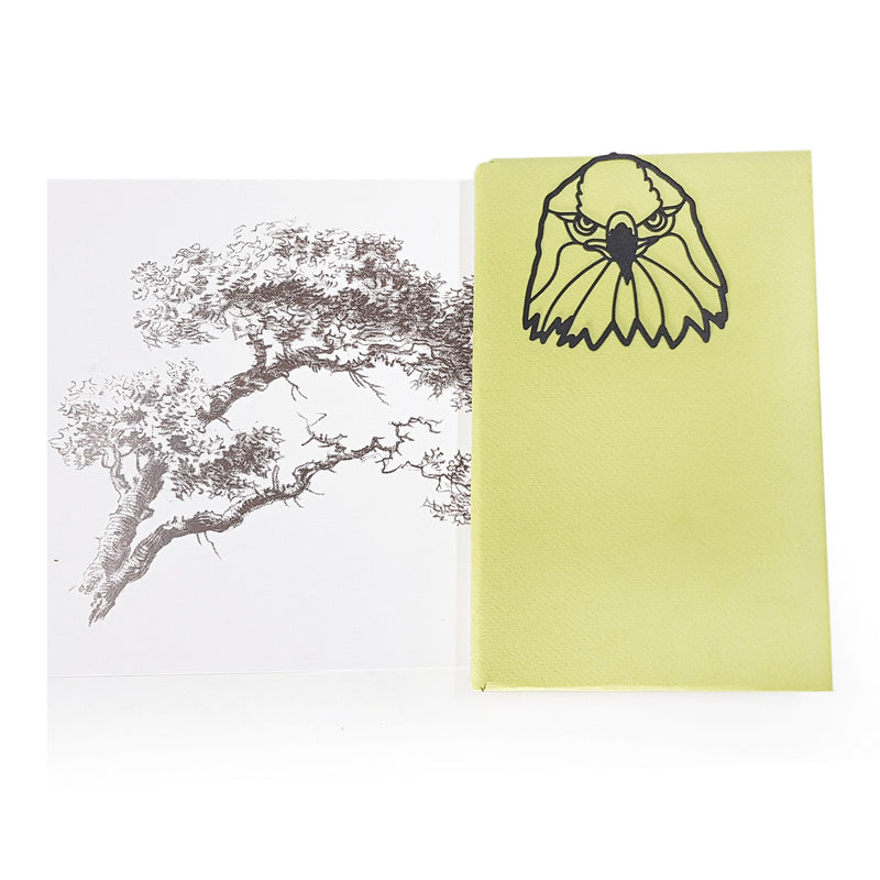 Eagle's Head metal bookmark marking a page in an illustrated book
