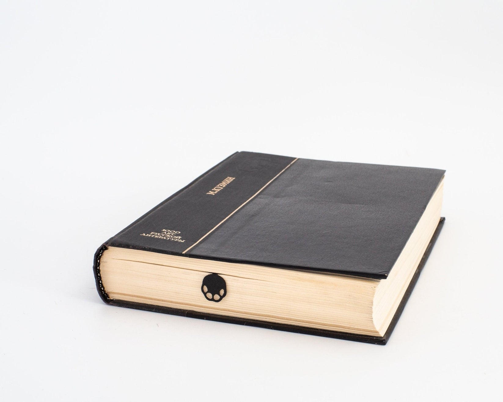 Elephant metal bookmark in a closed book, only its top showing above the pages