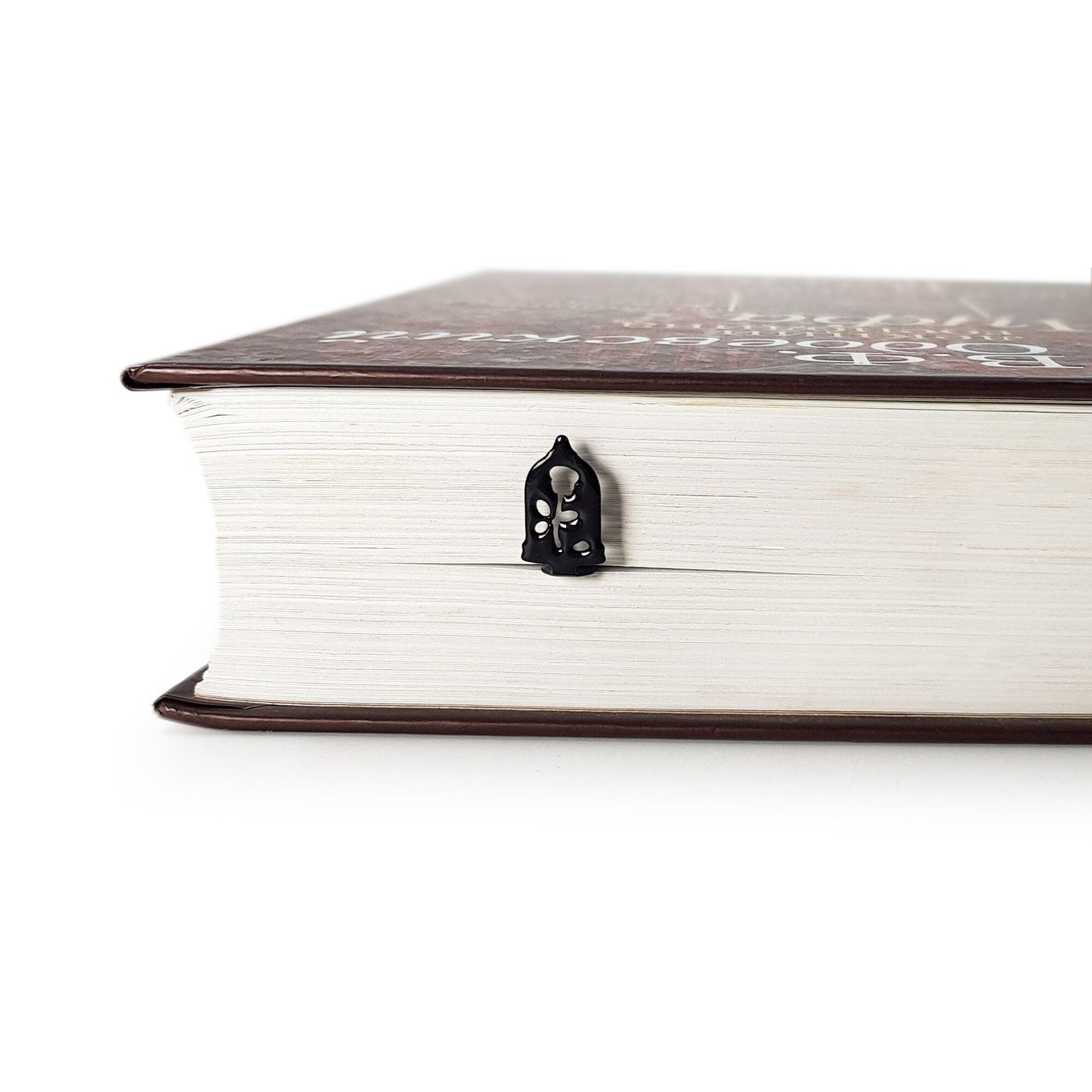 Enchanted Rose metal bookmark seen from the edge of a closed book