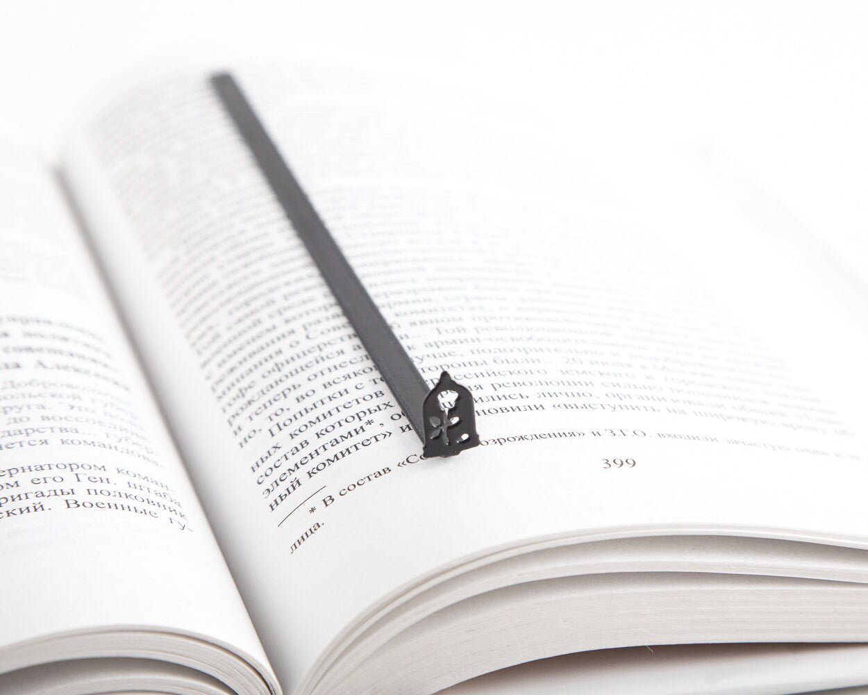Enchanted Rose metal bookmark resting on the pages of an open book