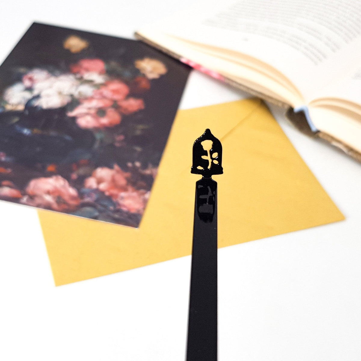 Enchanted Rose metal bookmark placed on a colour illustration